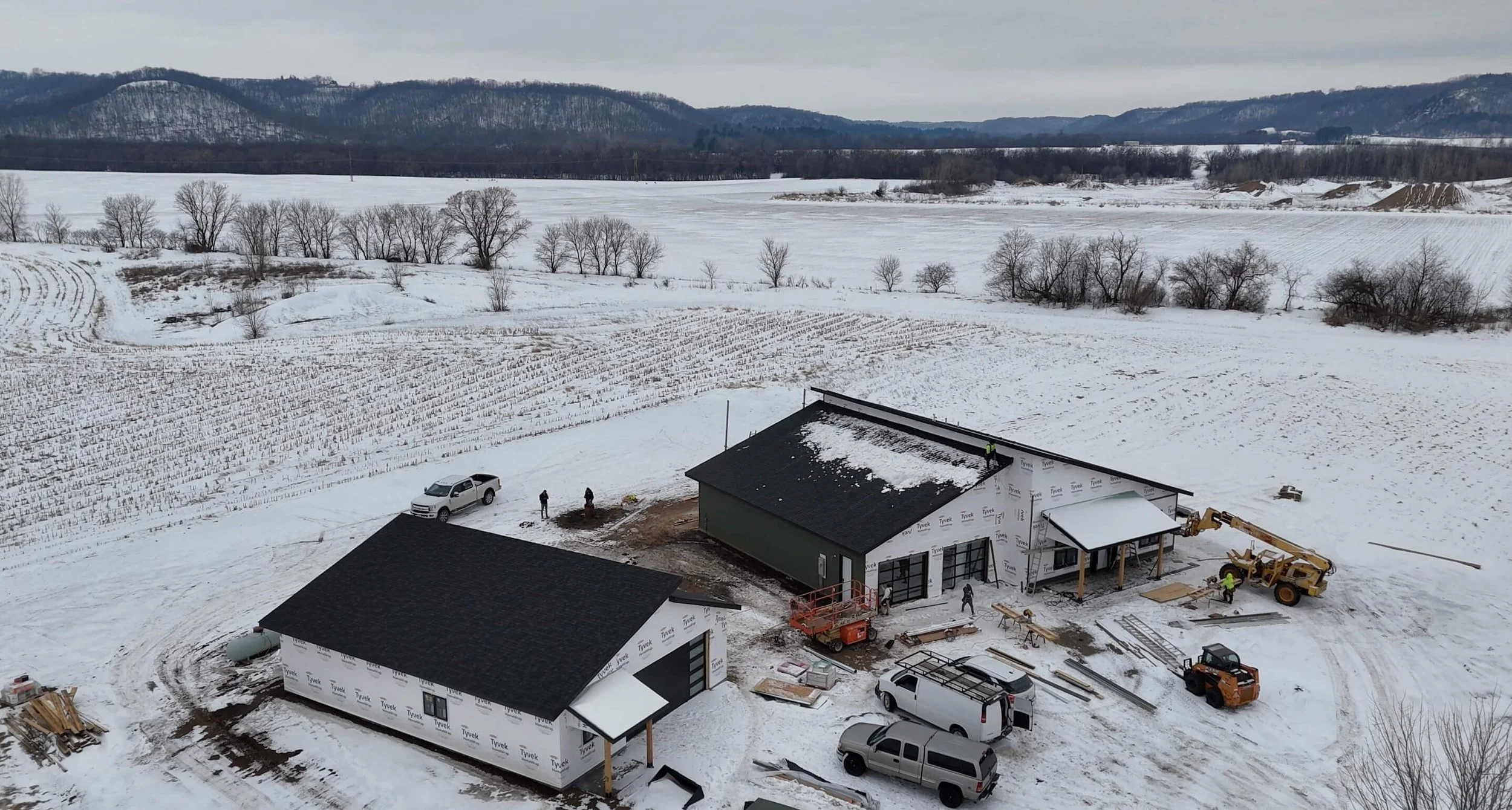 Aerial Shot of a New Construction Home with a shingle roof and LP siding installation in progress
