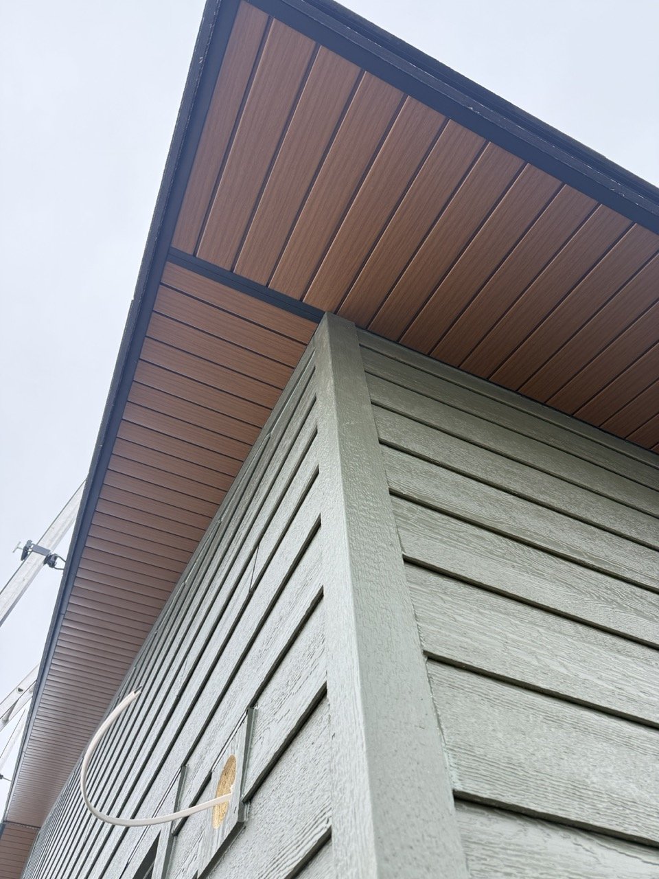 Green LP Smartside with Wood grain aluminum soffits