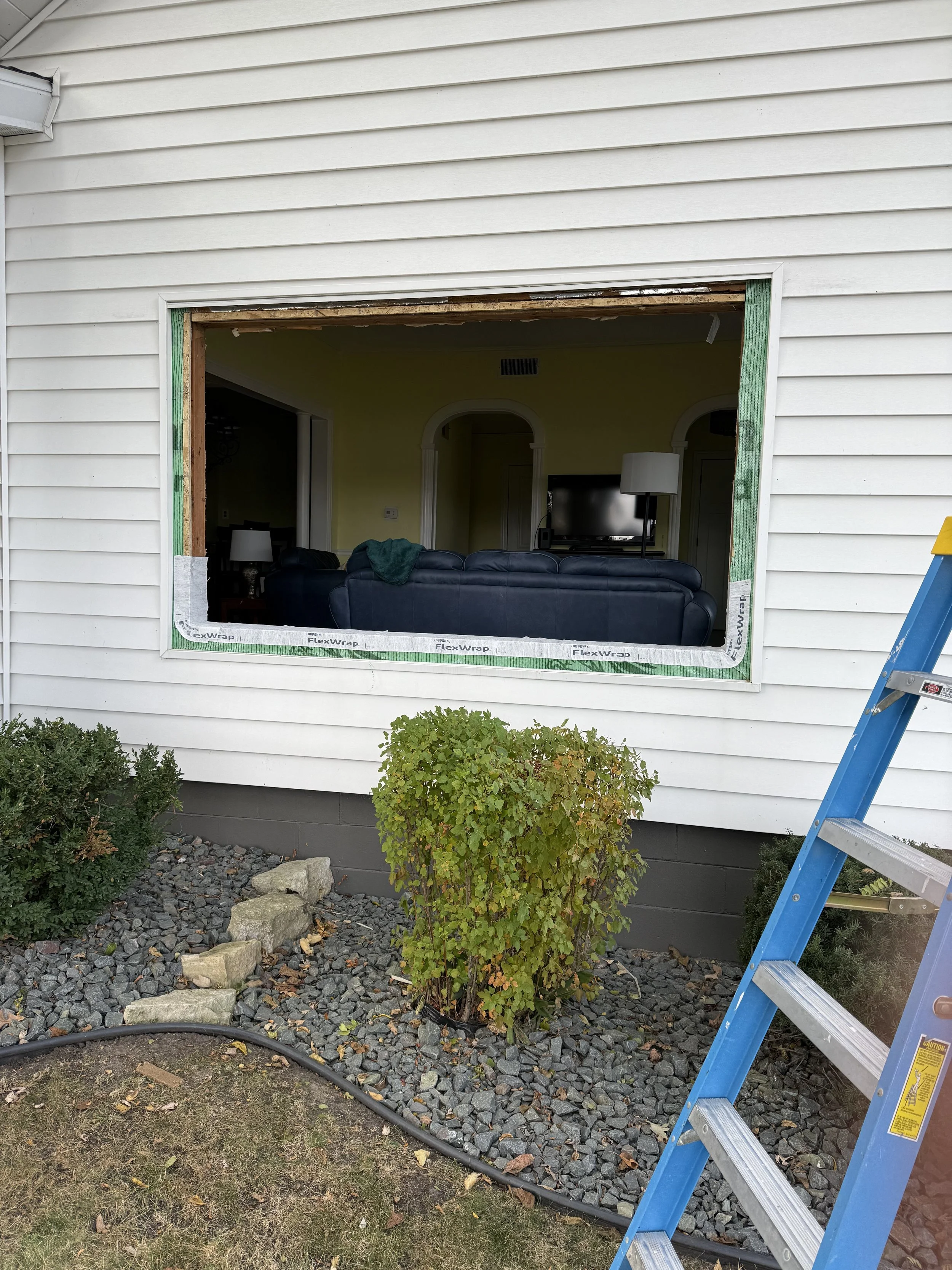 A new window being installed in a residential home in Lake City, MN by Skyline Roofing. It shows the window opening prepped and for the new window.