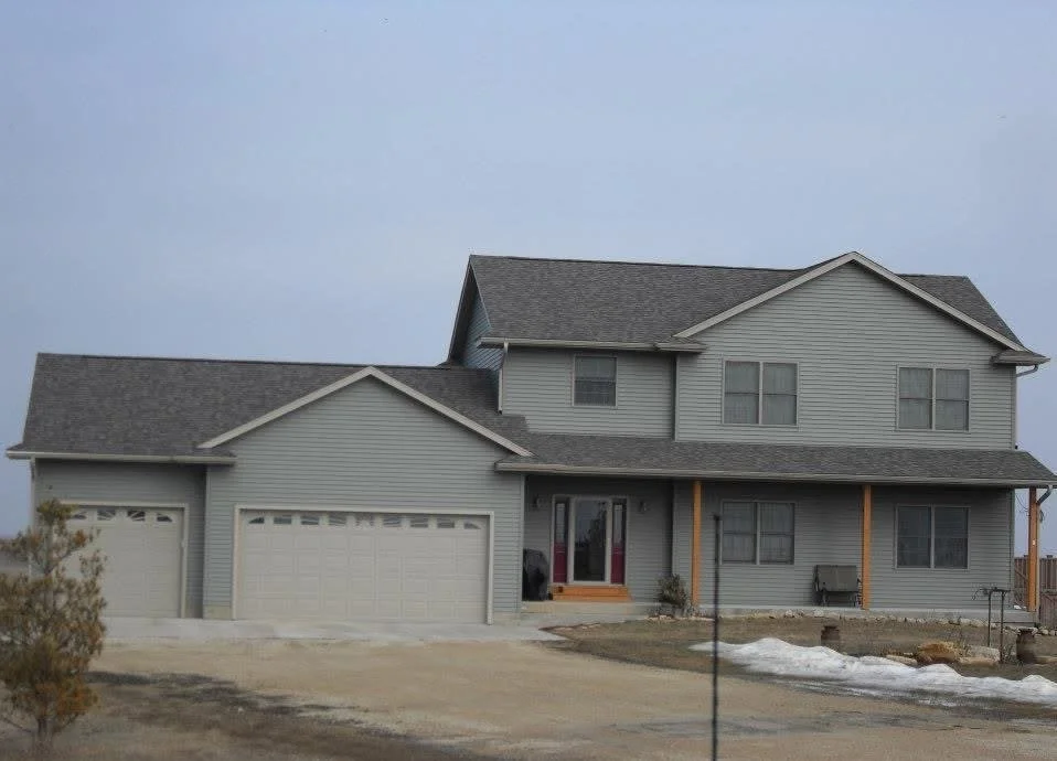 A residential house that has new siding, windows and roof systems.