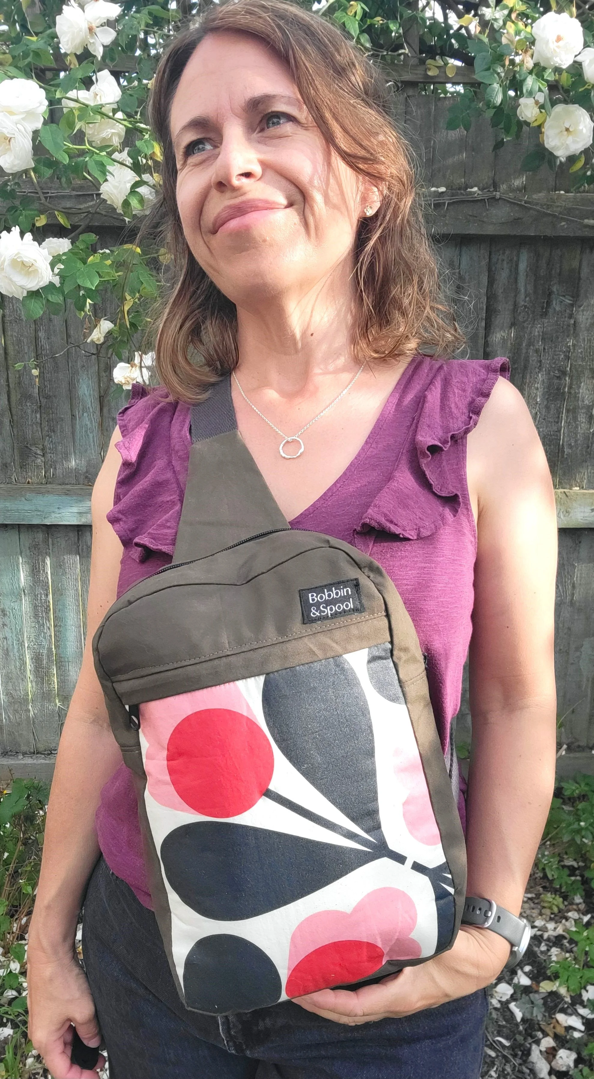 Olive retro flower sling bag on chest.jpg