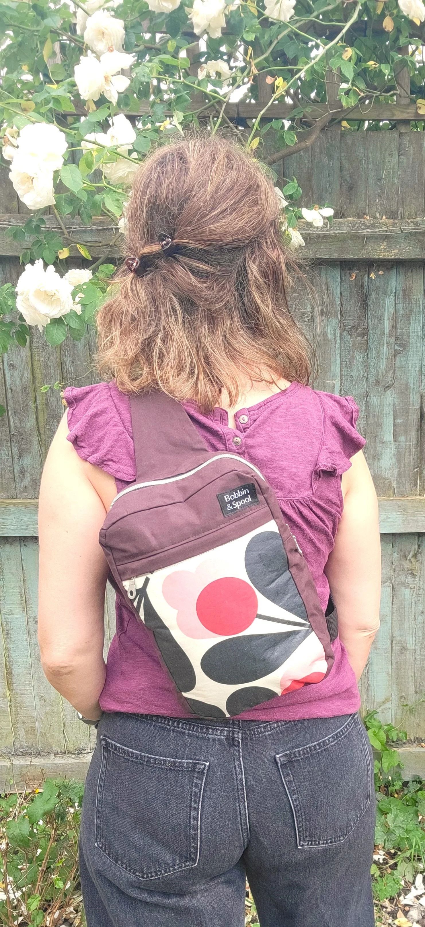Oxblood retro flower slingbag on back.jpg