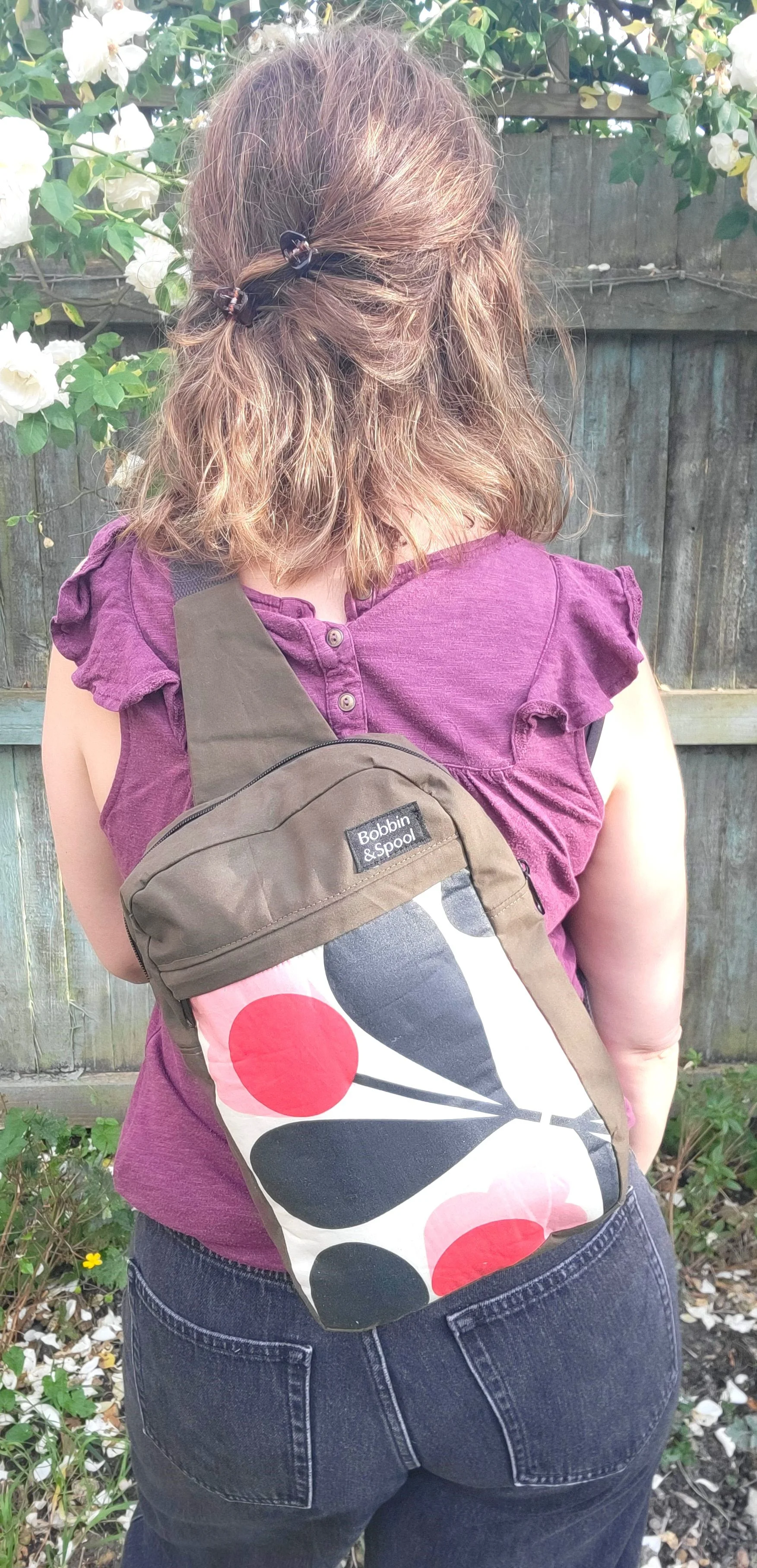 Olive retro flower sling bag on back.jpg