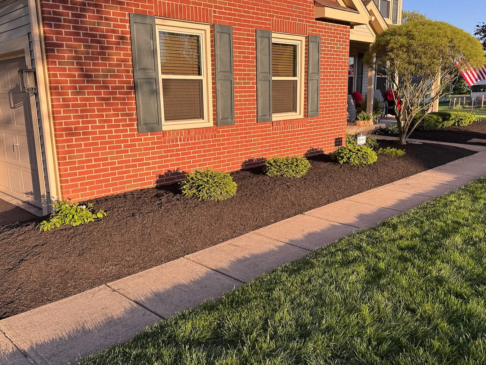 dark mulch installed around plants in beds