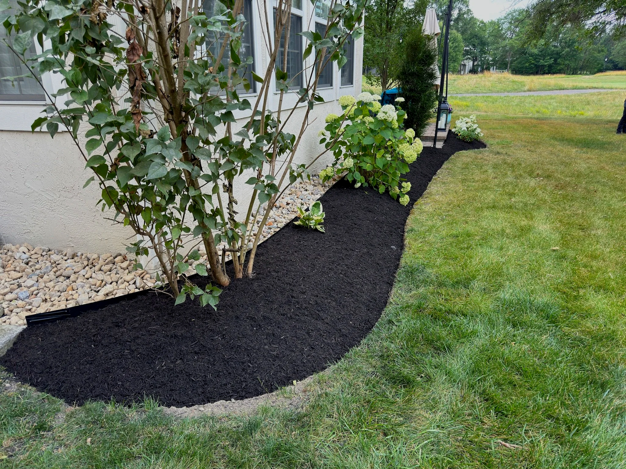 professionally edged flower bed with new mulch