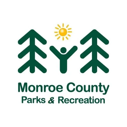 Logo for Monroe County Parks & Recreation featuring trees, a sun, and a person with raised arms.