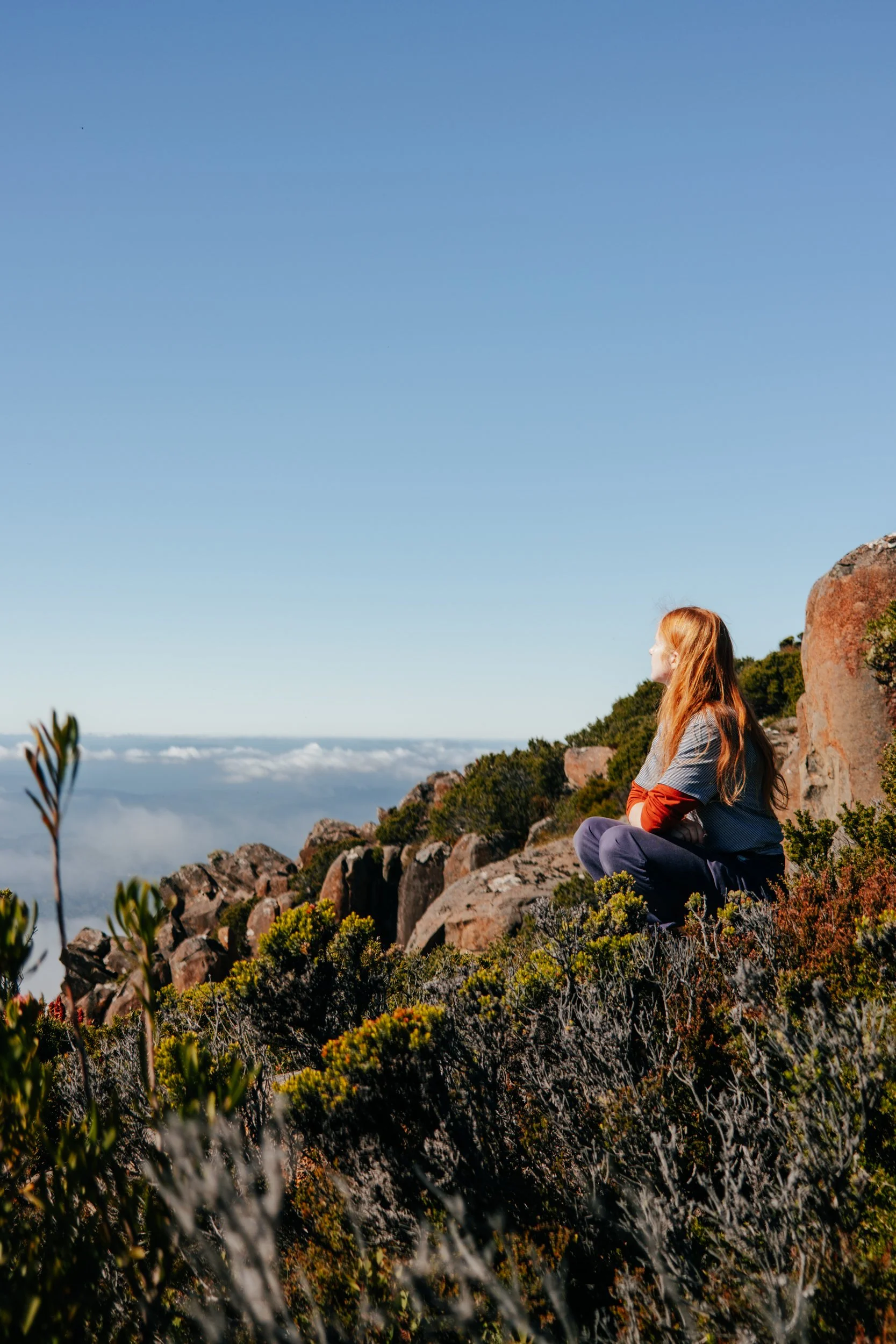 caitlin king - blue mountains based wedding and business photographer, showcasing her adventurous side of life, sitting down atop a mountain