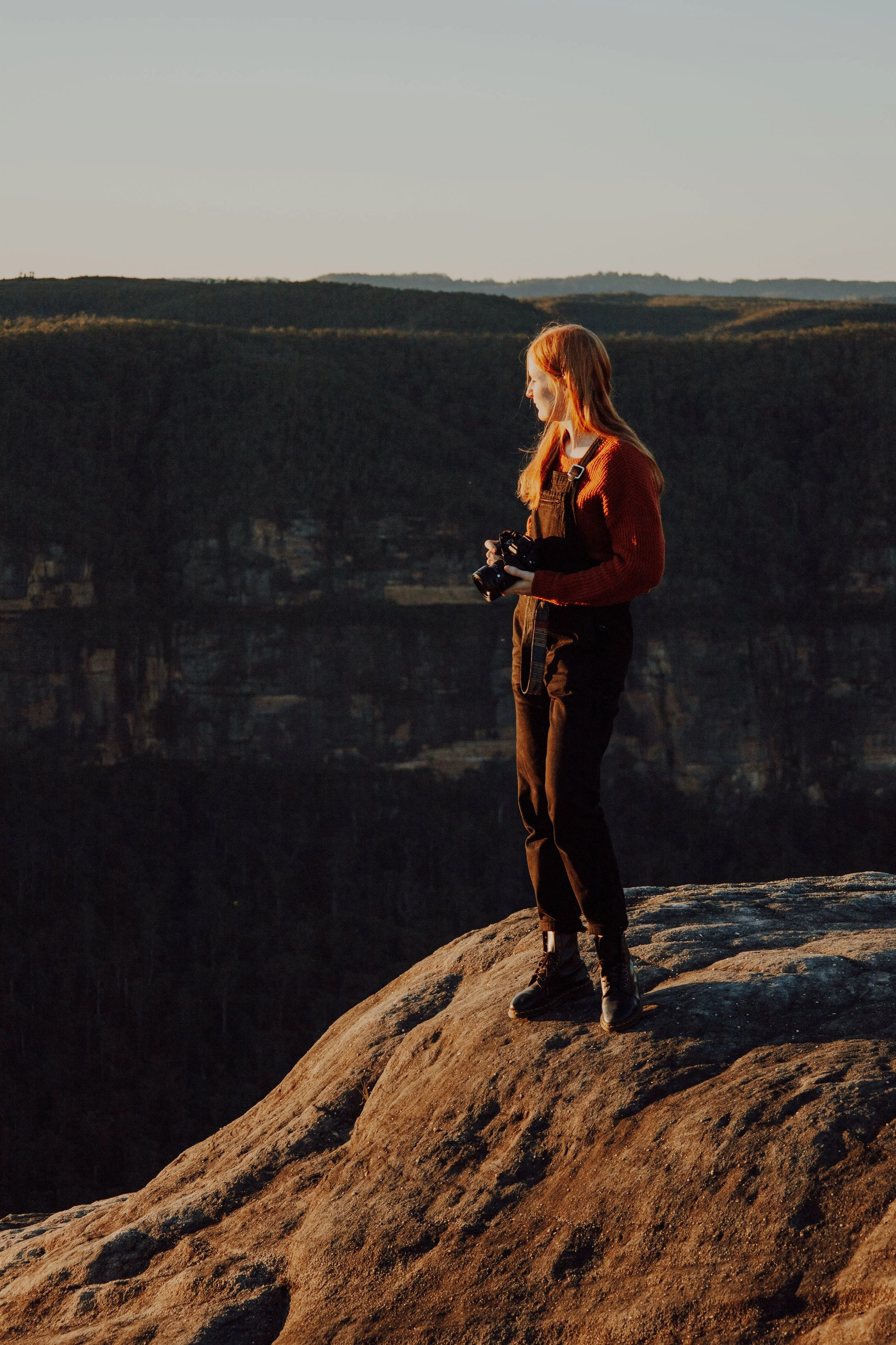 caitlin king - blue mountains based wedding and business photographer, sitting atop a cliff in the blue mountains national park