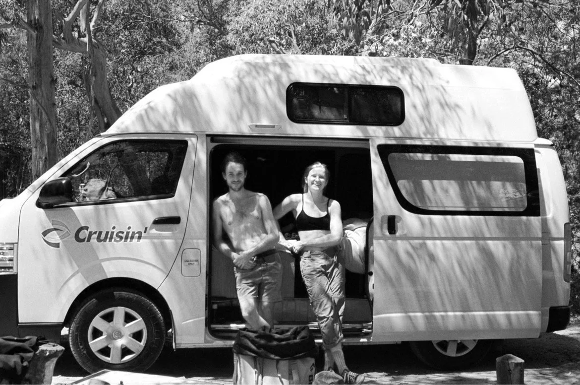 caitlin king - blue mountains based wedding and business photographer, showcasing her adventurous side of life, standing with her partner in front of a van while on a climbing trip interstate