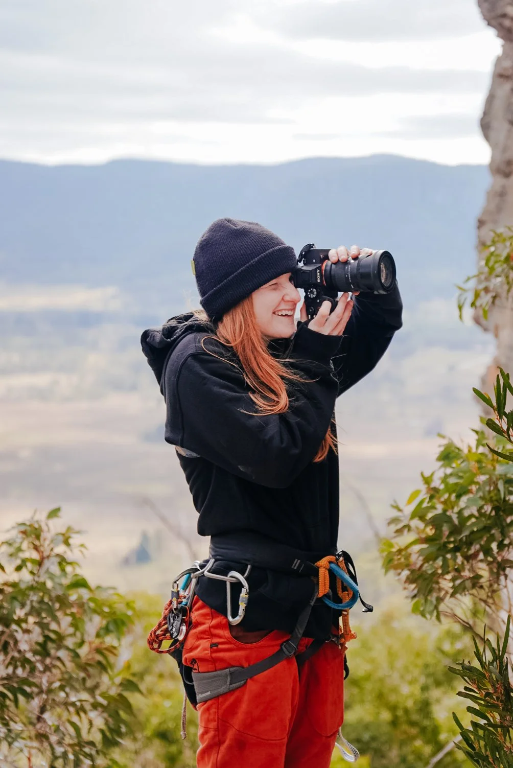 caitlin king - blue mountains based wedding and business photographer, showcasing her adventurous side of life, at a rock climbing place with her camera in hand