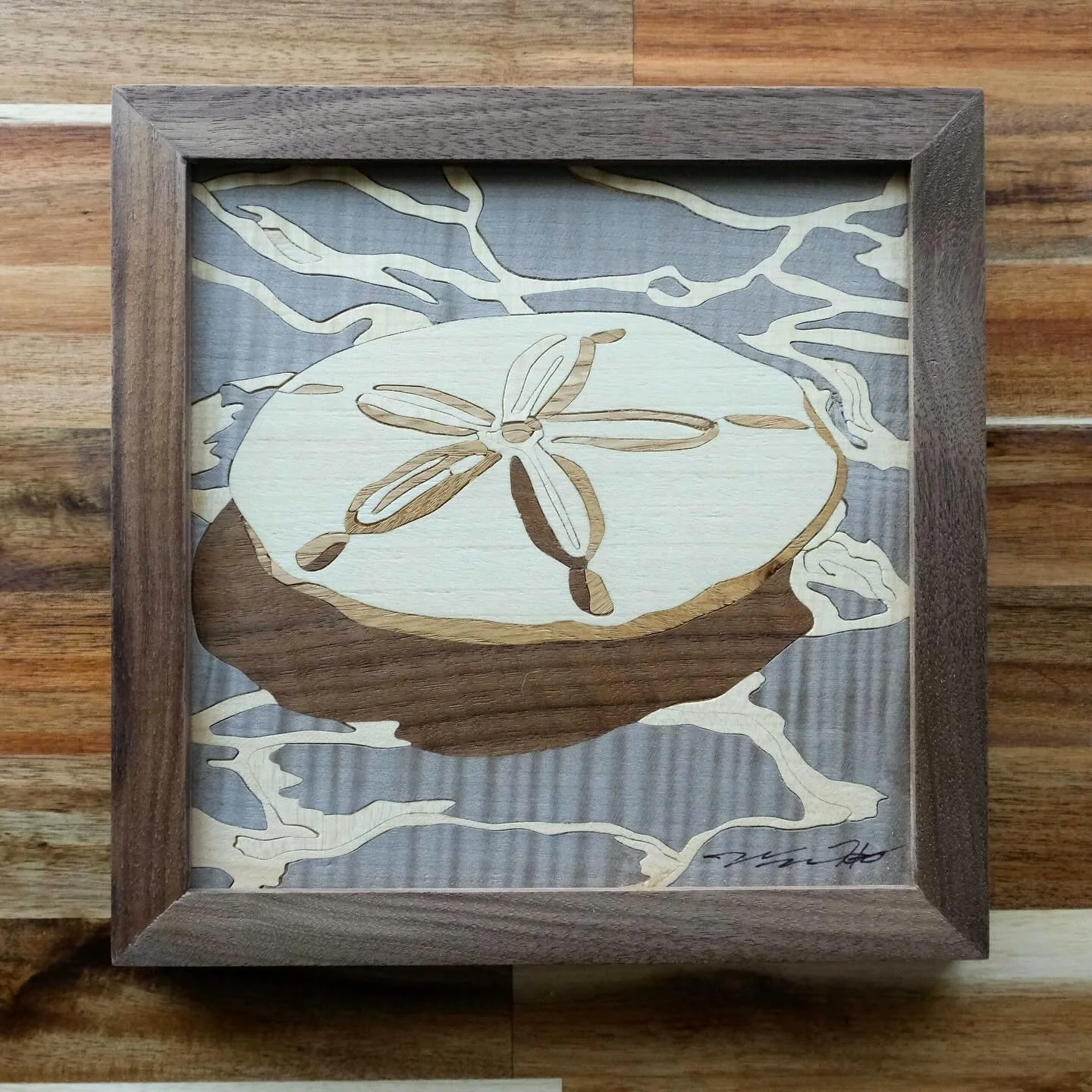 The final sand dollar in the coastal series features quilted silver sycamore, chosen for its rare, shimmering grain. Its luminous surface mirrors the play of light on water, adding a depth that only this type of wood could create