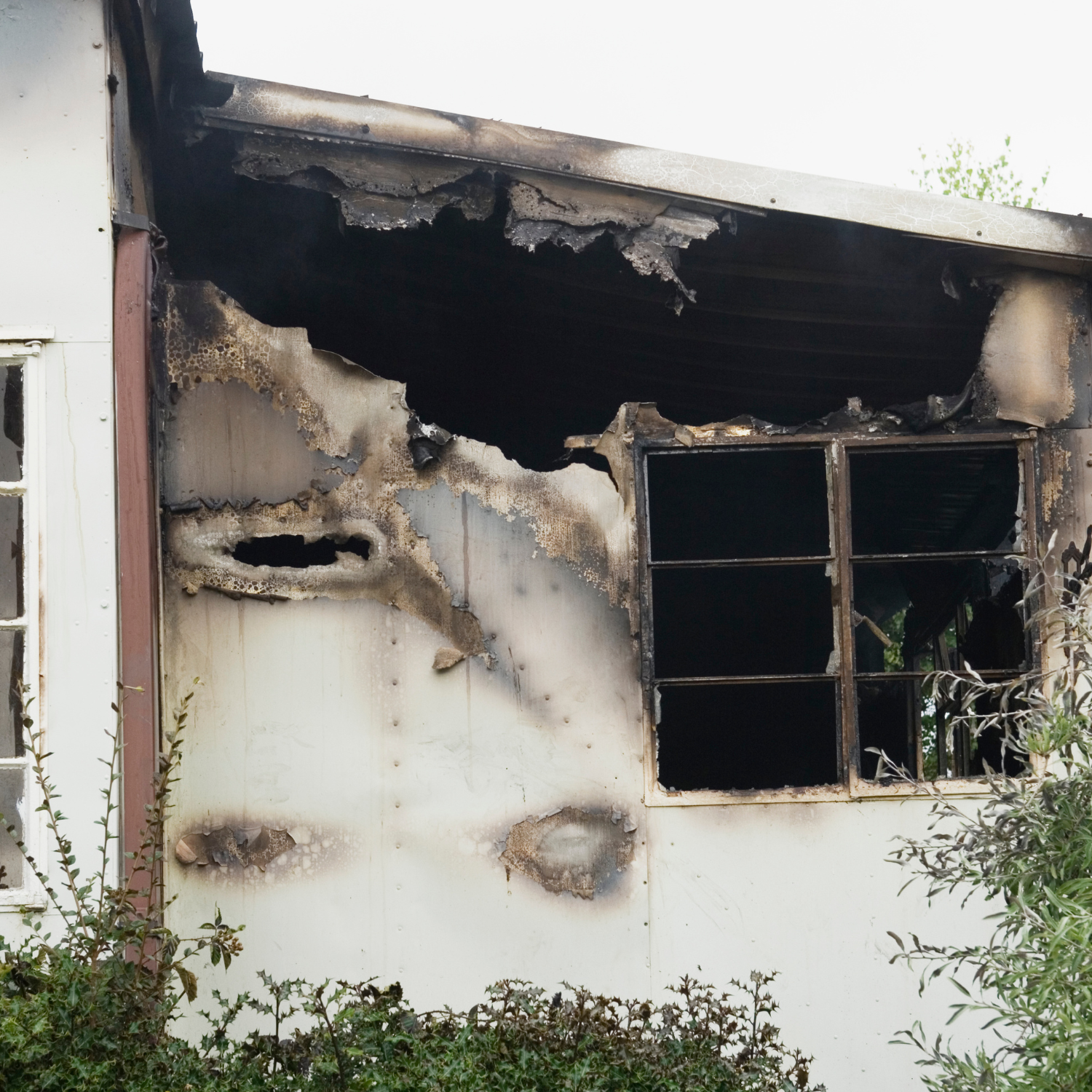 Exterior of a home with fire and smoke damage awaiting restoration