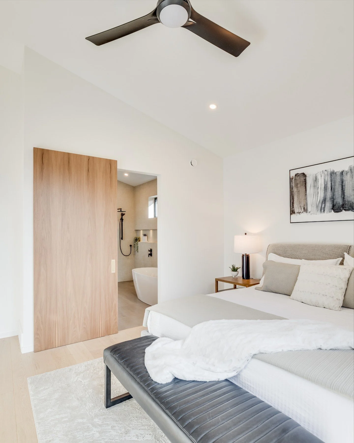 An oversized barn door is a smart solution for ensuite access - especially in primary bedrooms where space and ease of flow matter.

Here, the door allows for a wider opening without the swing clearance of a traditional hinged door. It keeps circulat