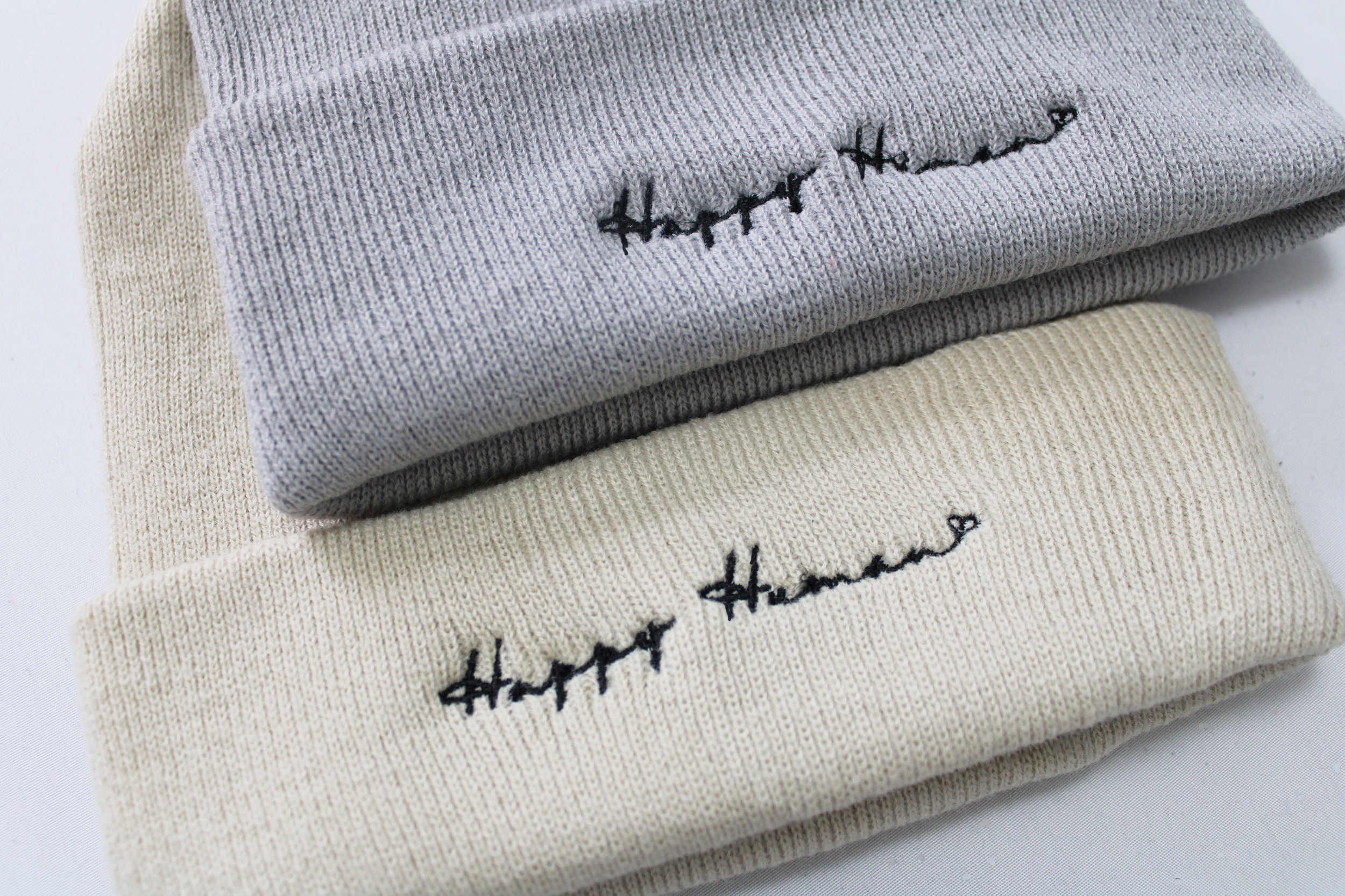 Happy Human beanies sand and light grey 2.png