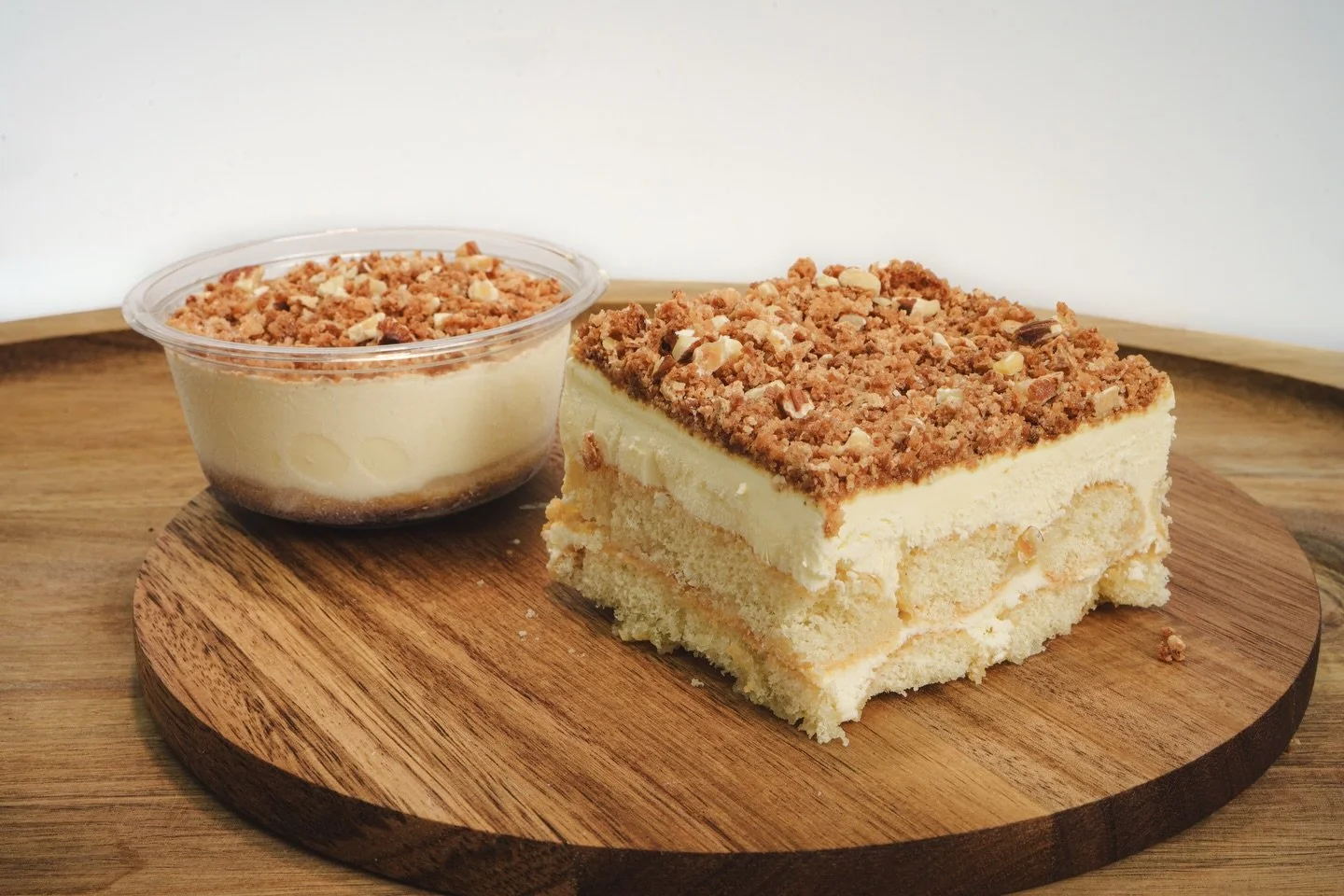 Toasted Almond Cream Cake: It&rsquo;s delicately soaked in ladyfingers with a amaretto syrup then layered with mascarpone cream &amp; topped with Italian amarettini cookies and roasted almonds. Sold by the tray or individual cups. 🇺🇸❤️🤍💙🇺🇸 #mem