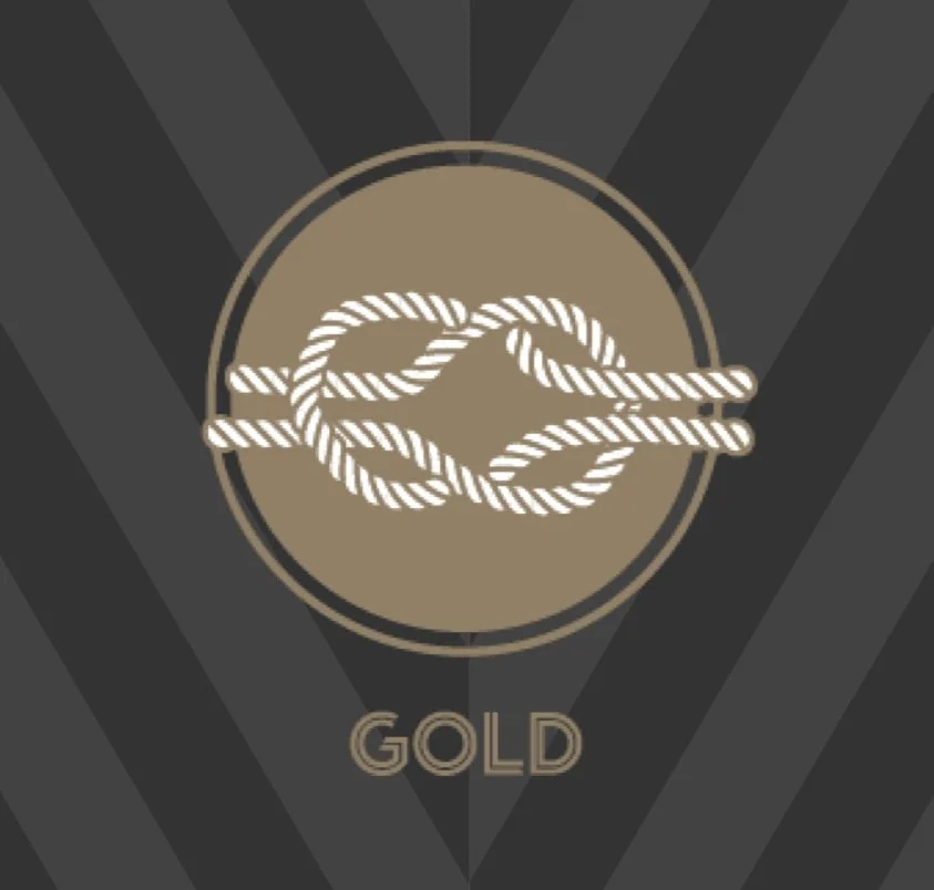 A logo with a white rope tied in a knot inside a circle, on a gold background, with the word 'GOLD' below it.