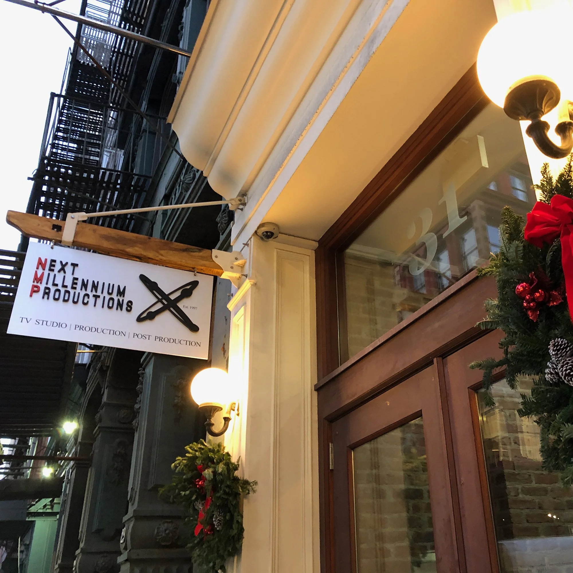NMP Soho studio front door entrance and sign with holiday wreath