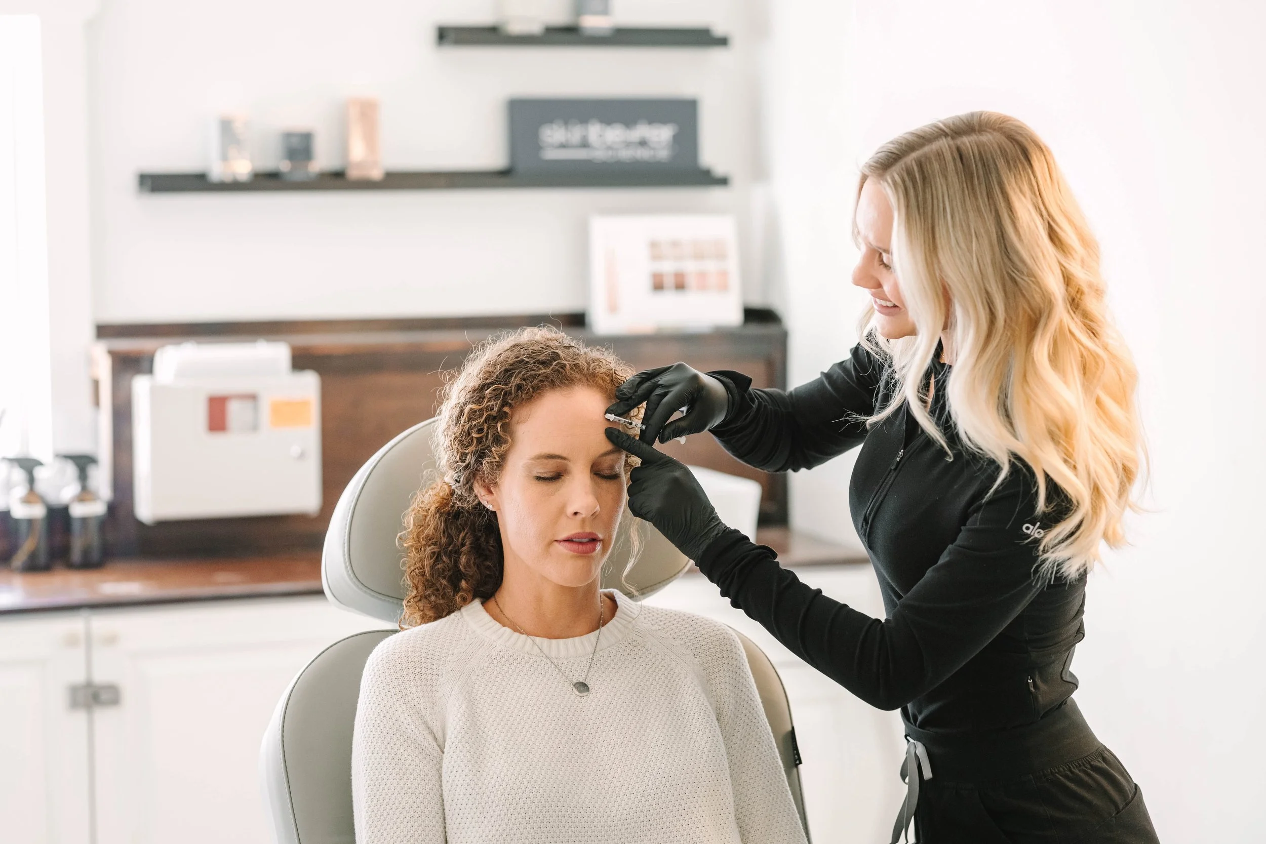 Nurse practitioner treating a client with a Botox injection