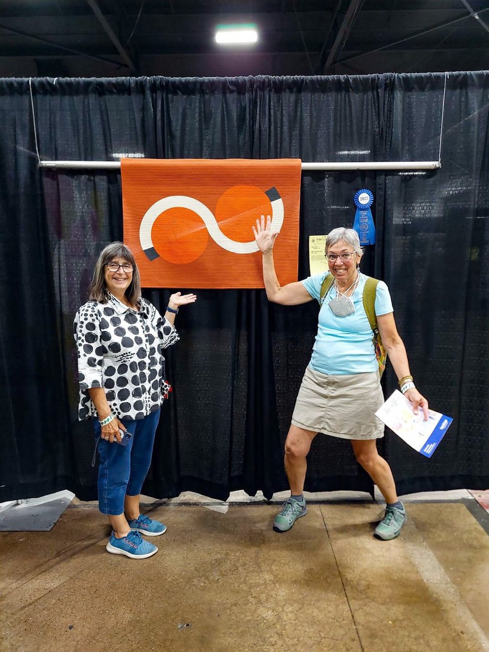 Betsy Vinegrad and AnnMarie Cowley stand with Vanilla Swirl at Pennsylvania National Quilt Extravaganza, Sept. 2022