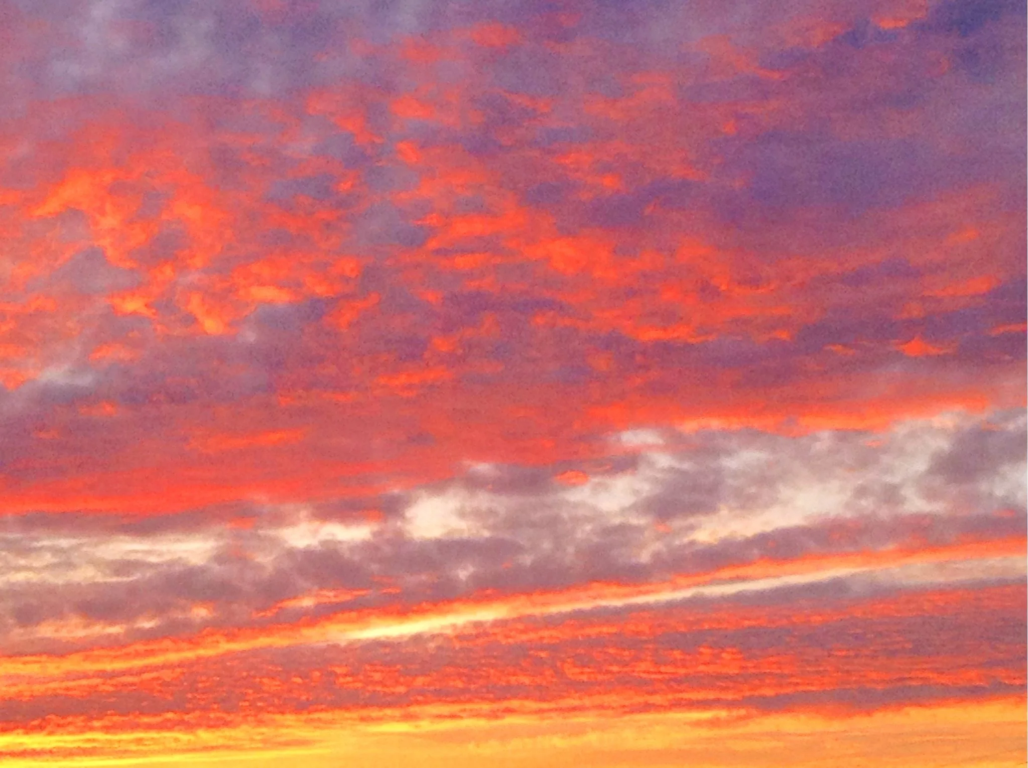 Colorful sunset sky with pink, purple, orange, and yellow clouds.