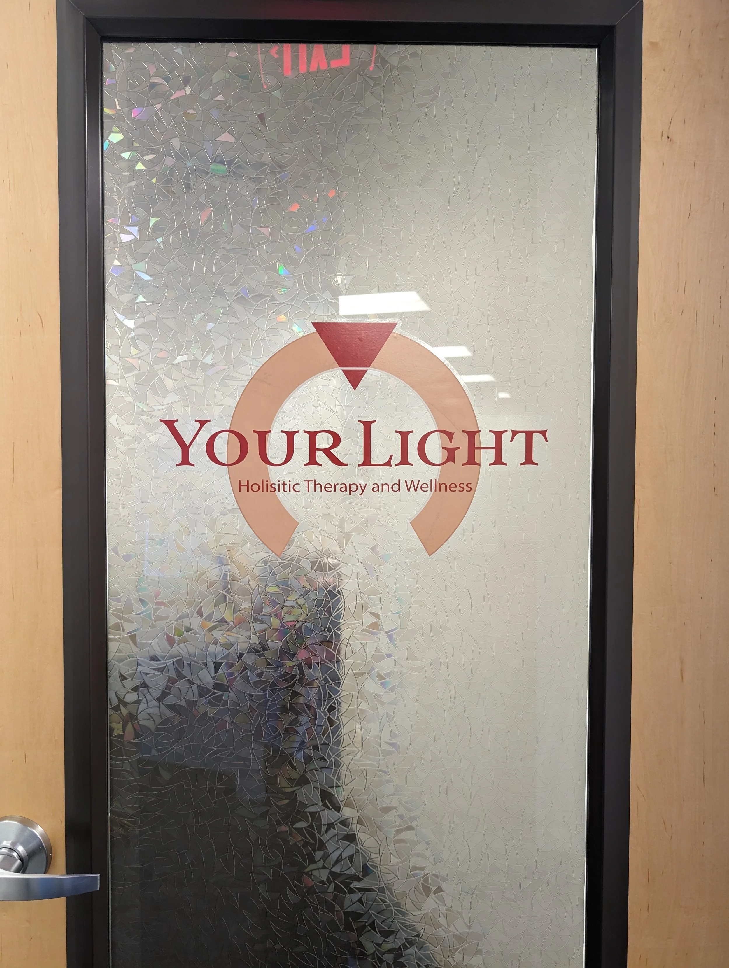 Image of office door including Your Light Holistic Therapy and Wellness logo