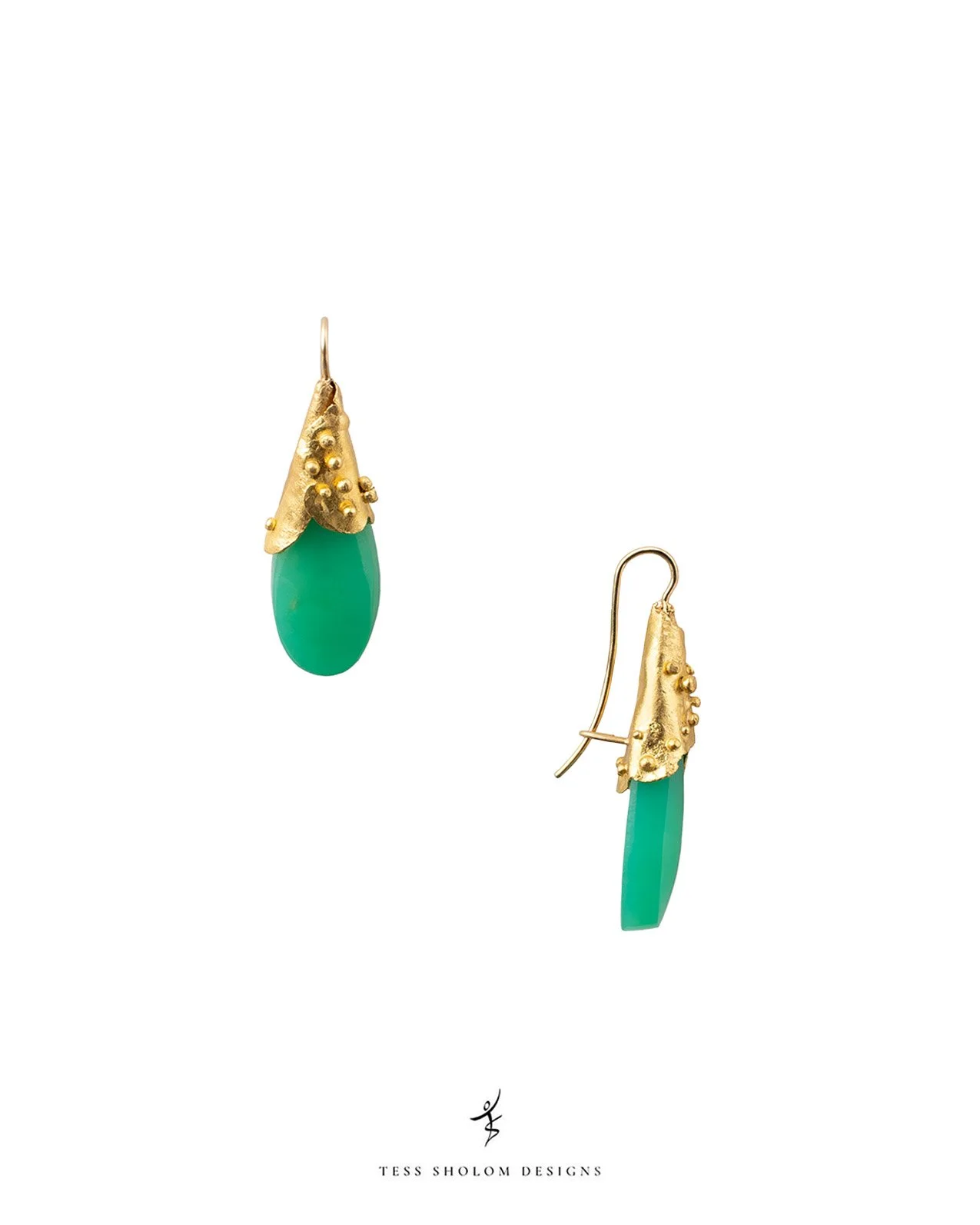 Pair of earrings with gold embellishments and green stones on a white background, with the brand name Tess Shalom Designs at the bottom.