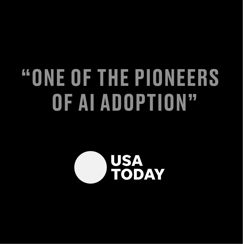 A black background with the quote 'One of the pioneers of AI adoption' in gray text at the top and the USA Today logo with a white circle and bold black text below.