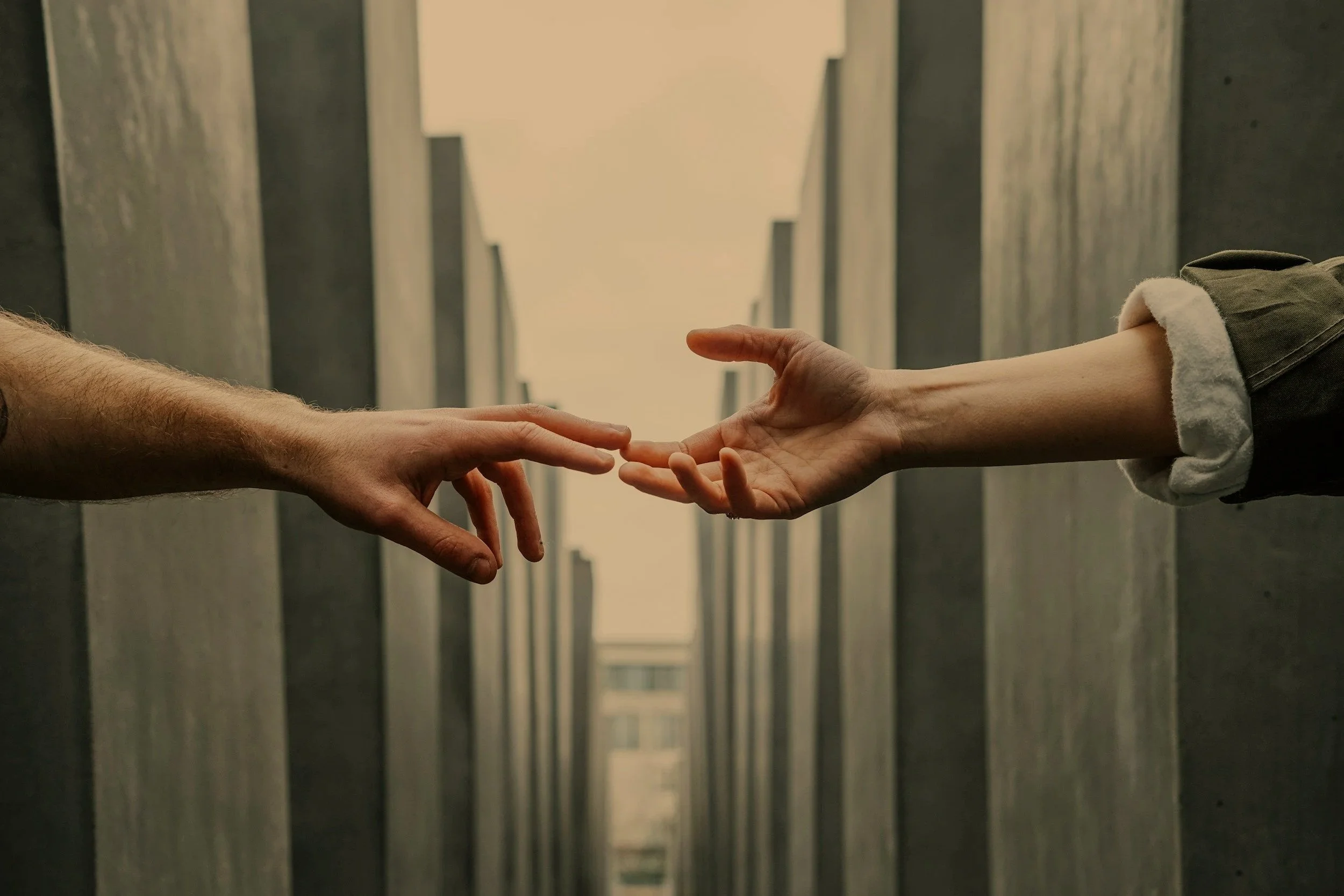 two hands reaching across the distance