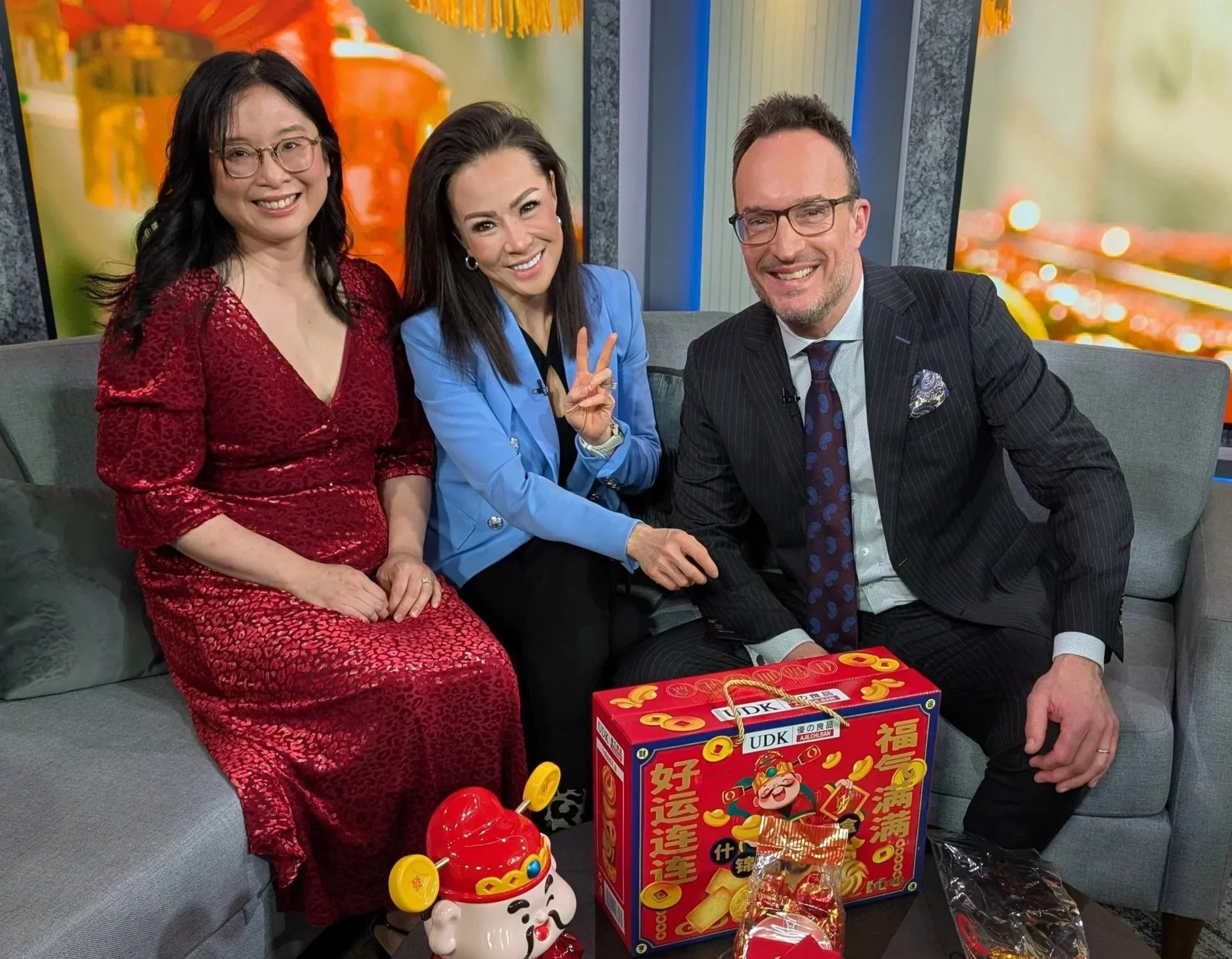 three people in a casual pose, two women of colour
