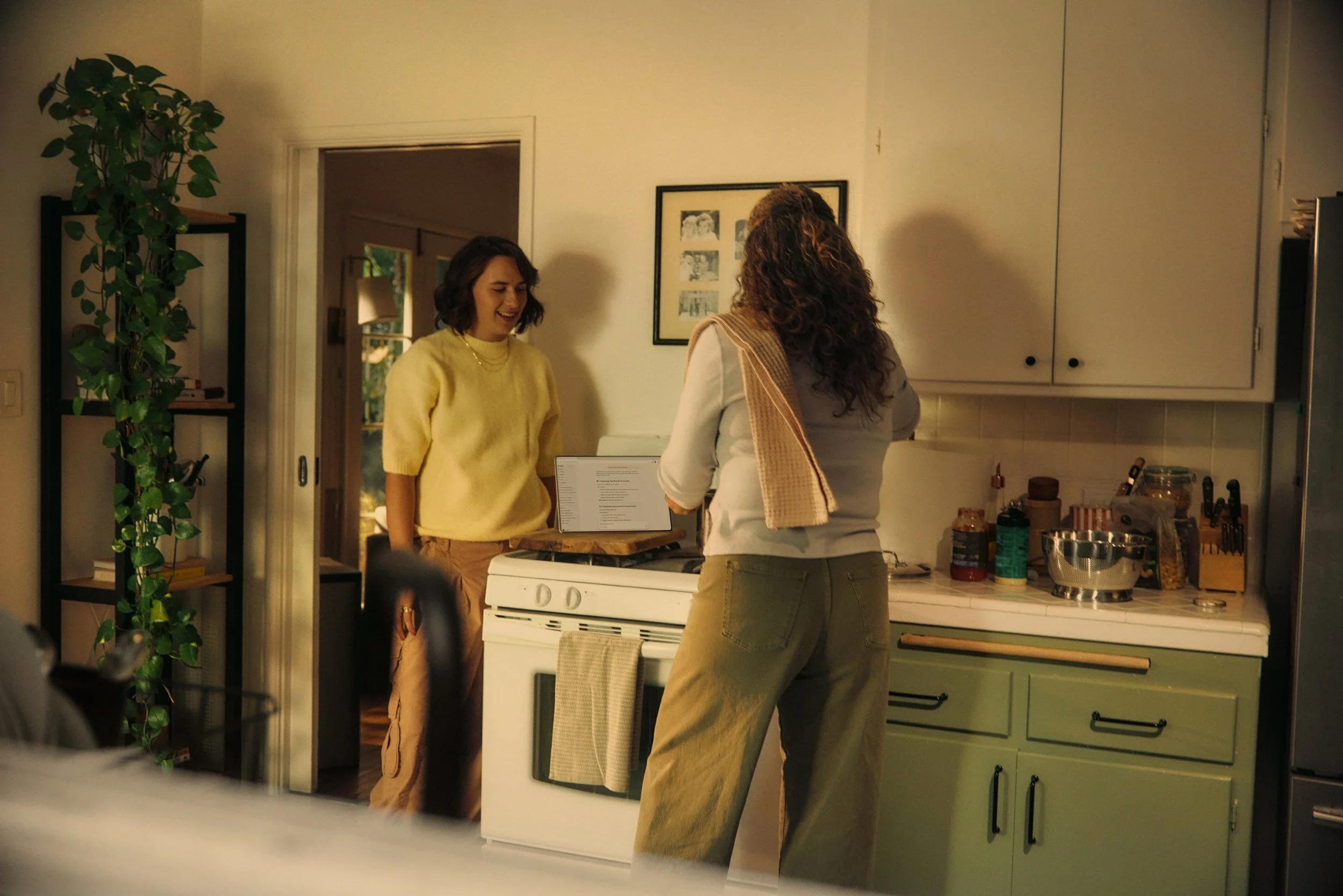 two women talking in a kitchen