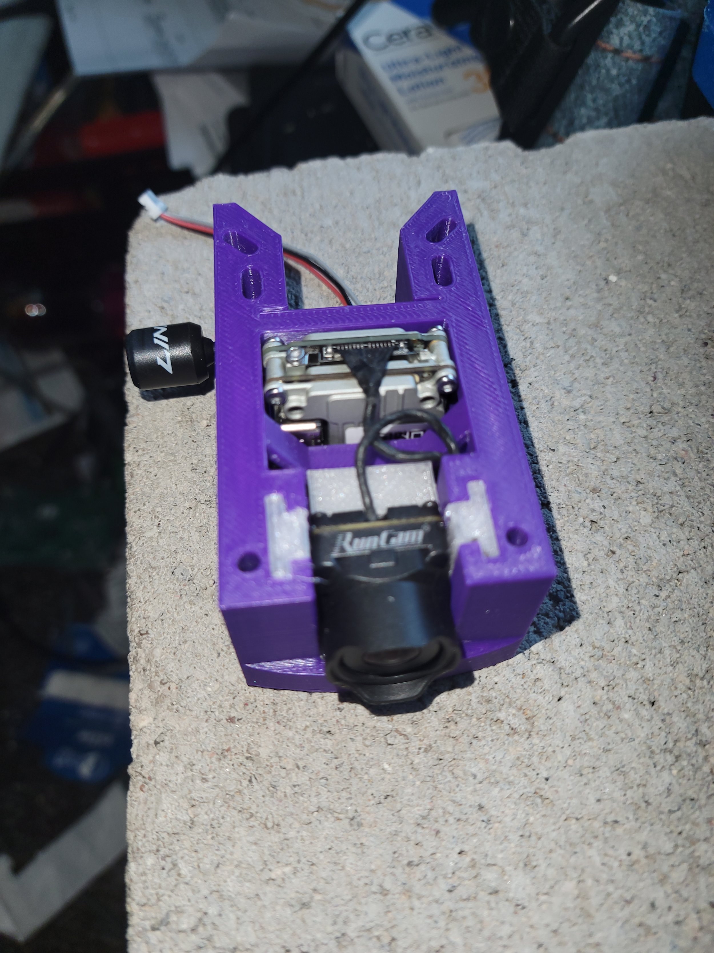 This frame was built before digital video systems and I wanted to put a caddx starlight in it. Given the non-standard mounts I designed my own camera and vtx mount with a side mounted antenna. This was a mark II version.