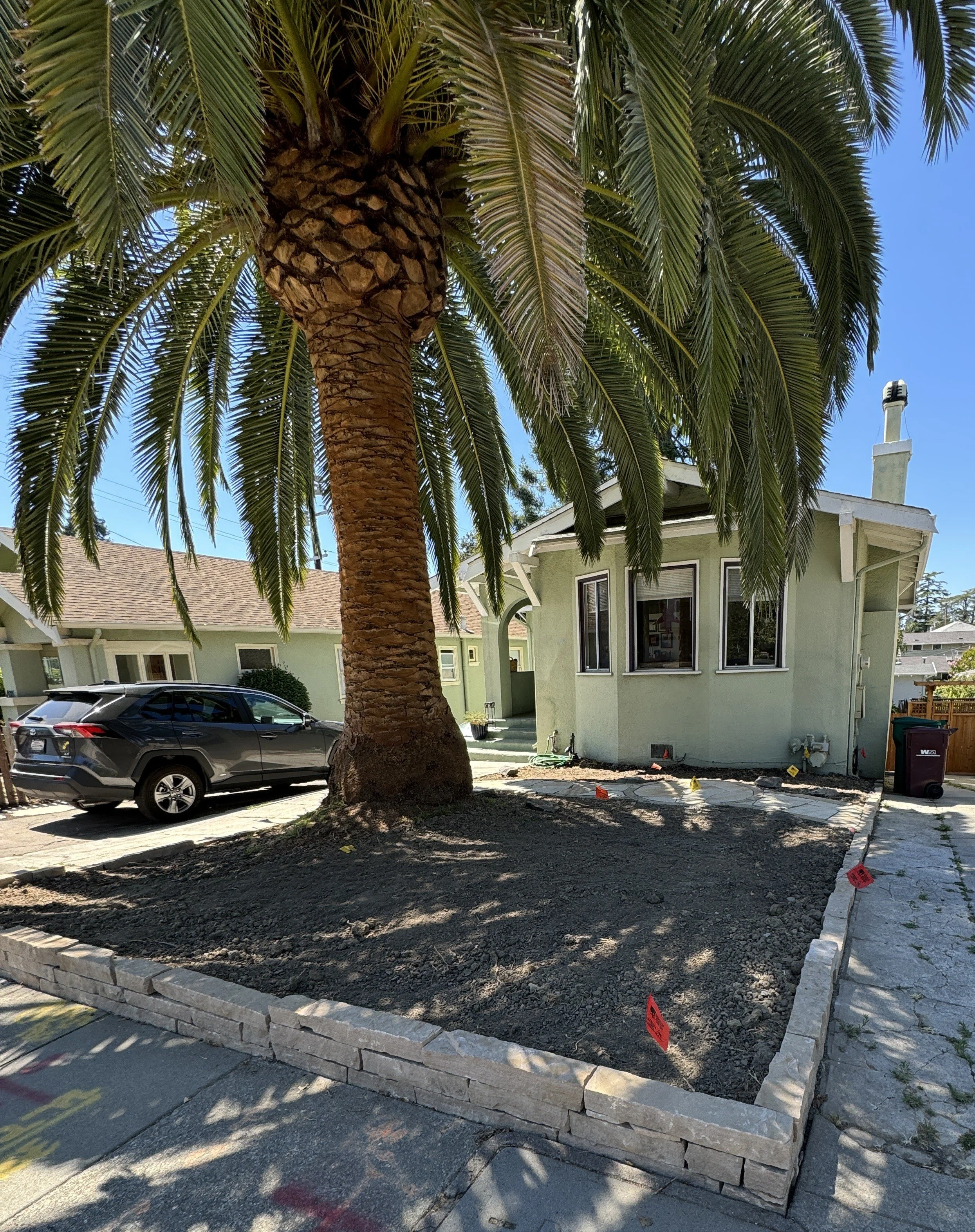 After Oakland Stone Design and crew cleared site and installed stone work and after tree has been trimmed