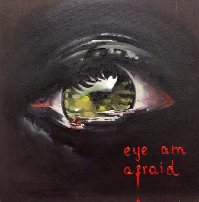 Close-up of a human eye with the phrase 'eye am afraid' written in red near the bottom.