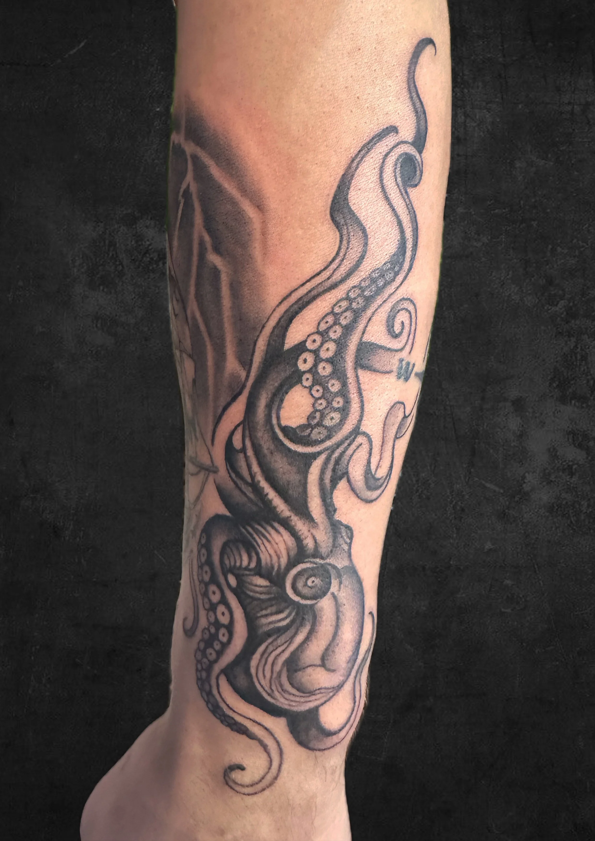 Tattoo of an octopus on a person's arm.