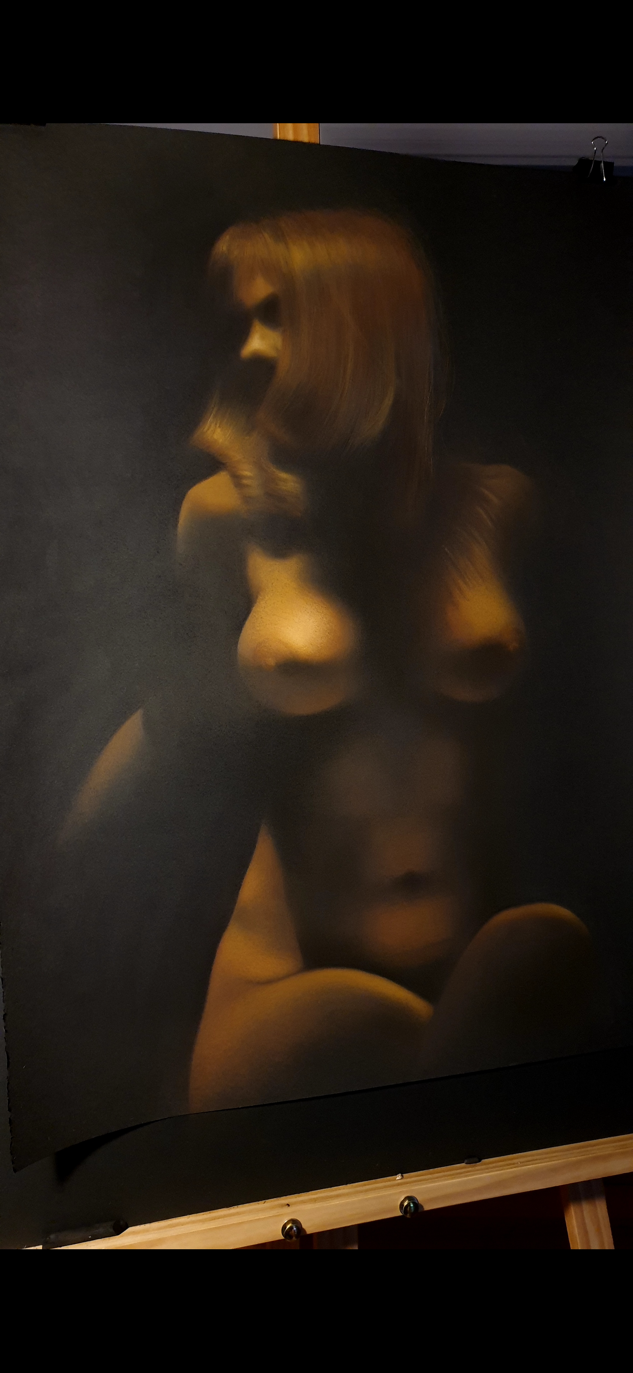 A hyper-realistic painting of a nude woman with long hair, shown in profile against a dark background.
