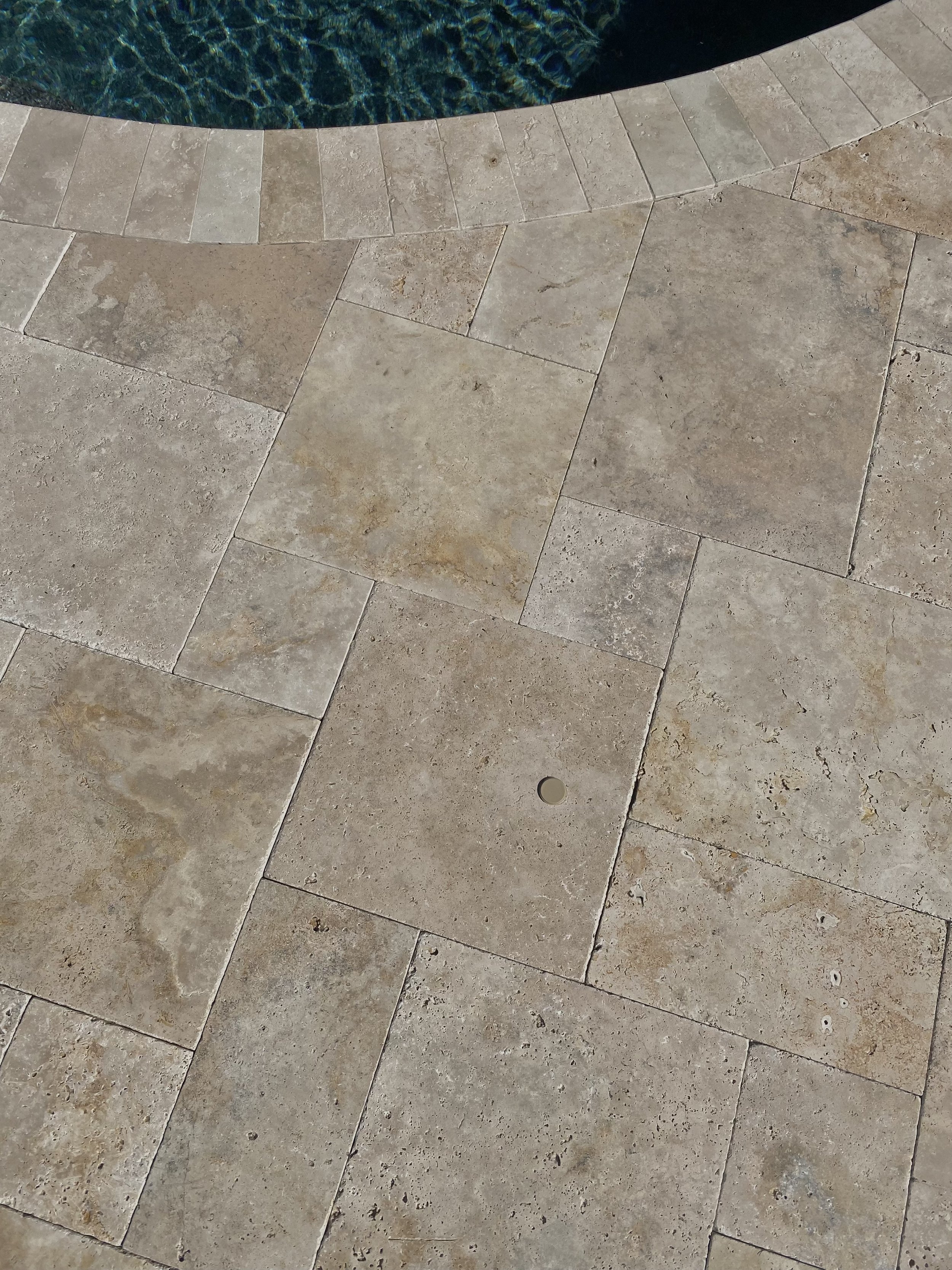 beige baby barrier deck caps on travertine pool deck
