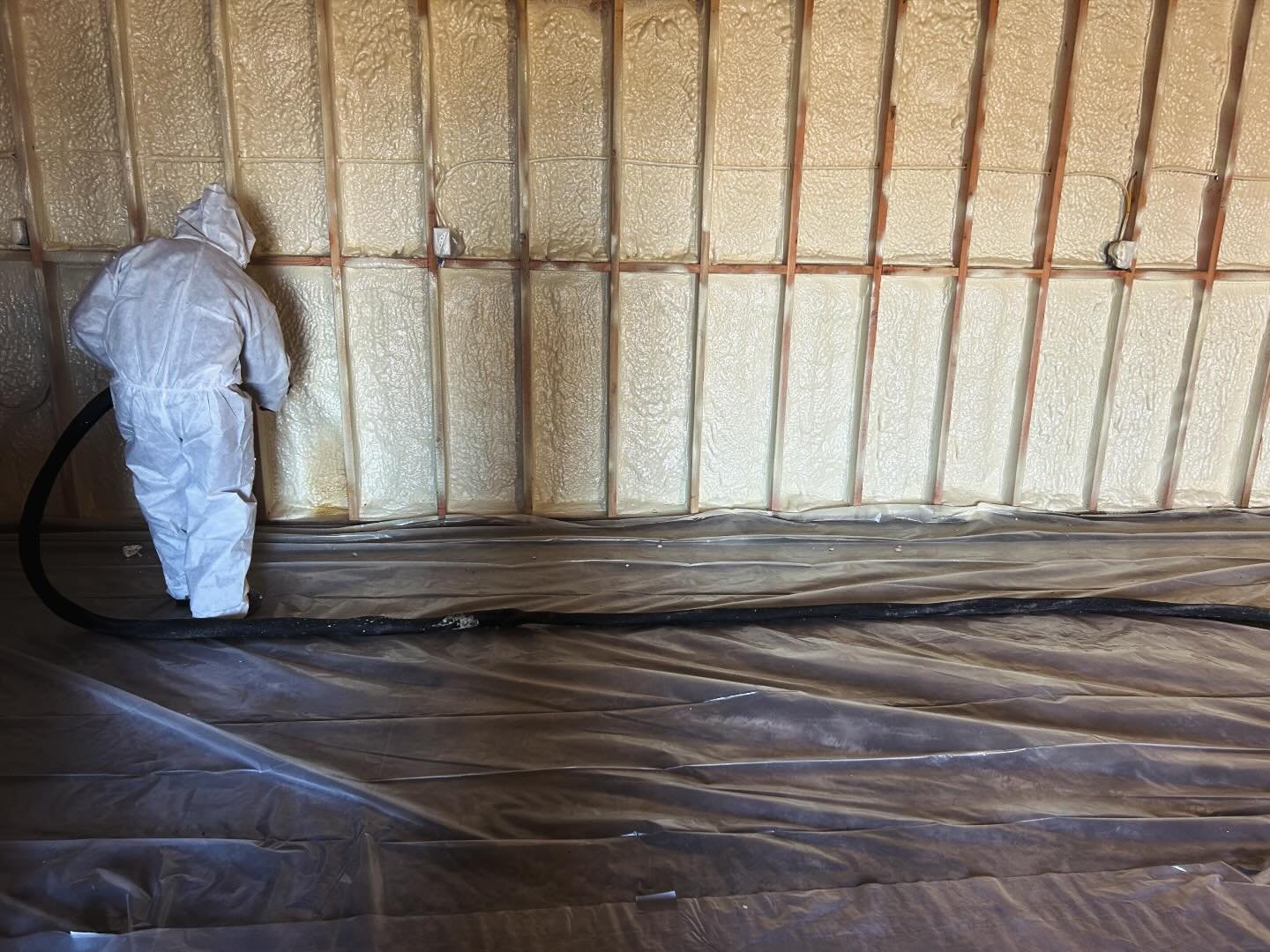 Base Camp Spray Foam, man spraying in a large garage