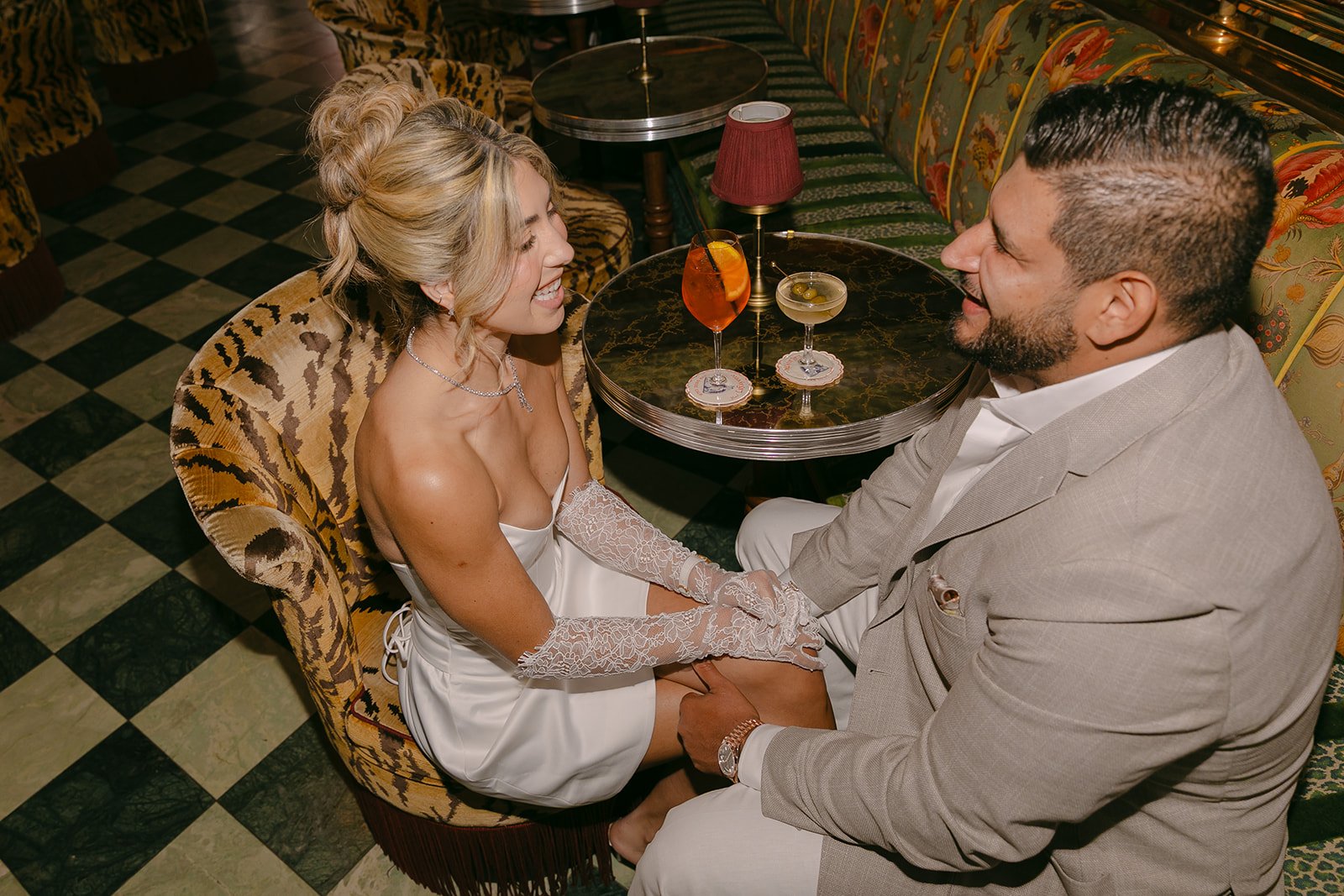 A couple laughing over drinks