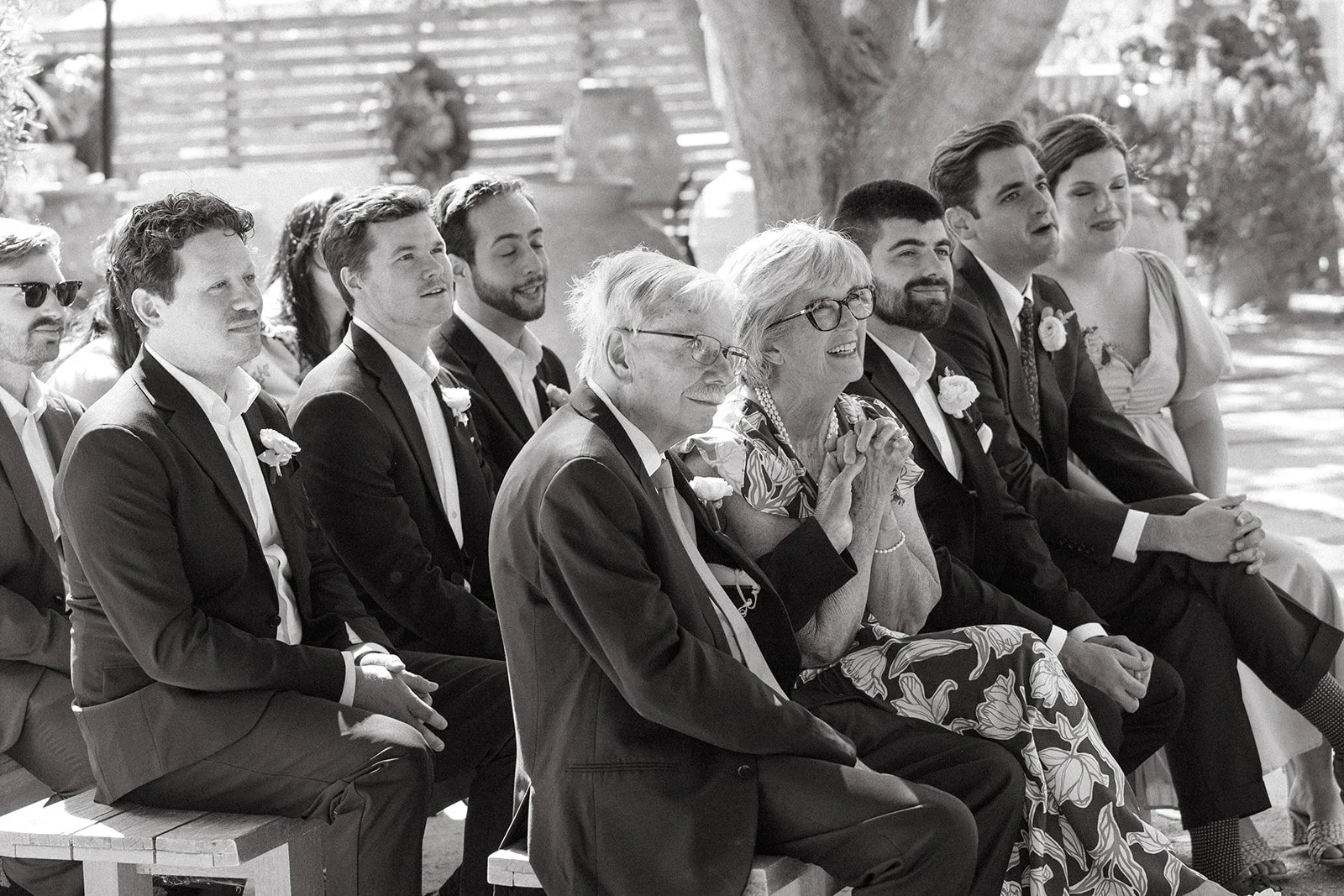 Wedding guests watching an outdoor wedding ceremony