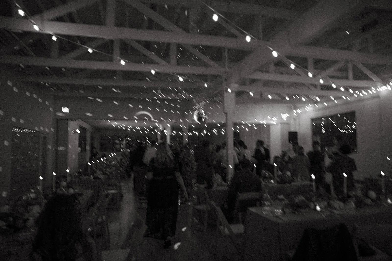 A black and white blurry wedding reception photo