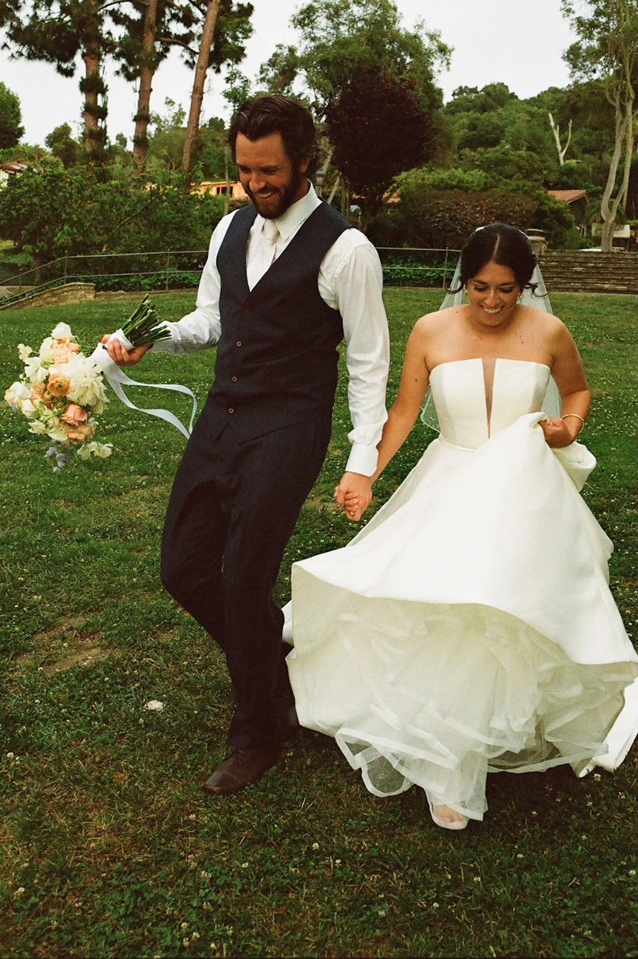 The newlyweds joyfully walking hand in hand, radiating love and laughter during their intimate wedding celebration.