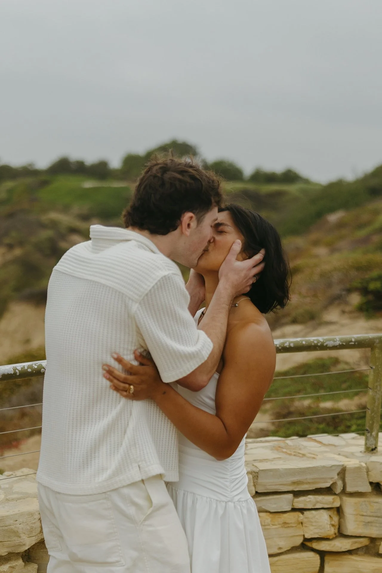The bride and groom sharing their first kissing during their elopement on the beach