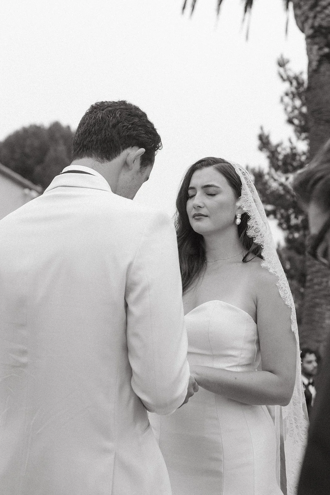 Black-and-white moment of the couple sharing their first kiss at a Historic Wedding Venue.