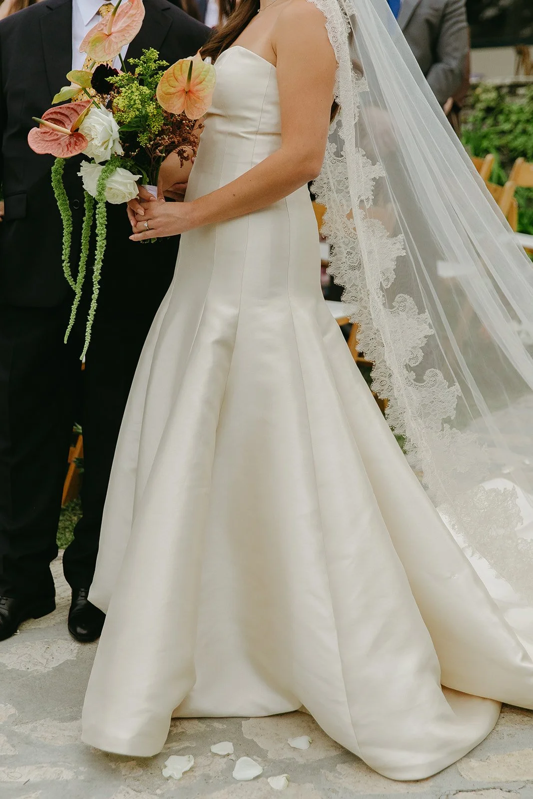 Side profile of the bride holding a modern floral bouquet during the ceremony at a Historic Wedding Venue.