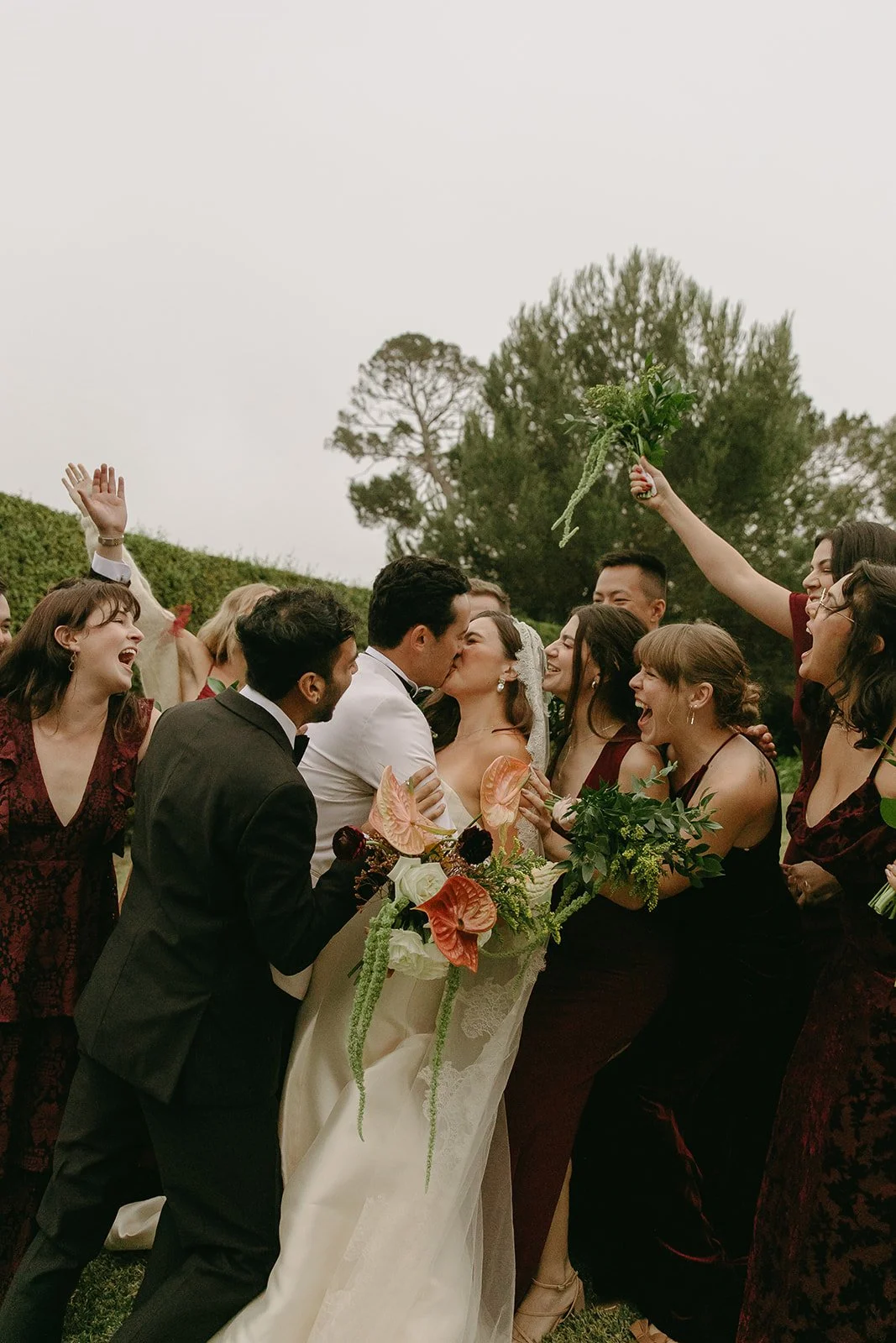 Bridal party cheering and surrounding the couple during a celebratory moment at a Historic Wedding Venue.