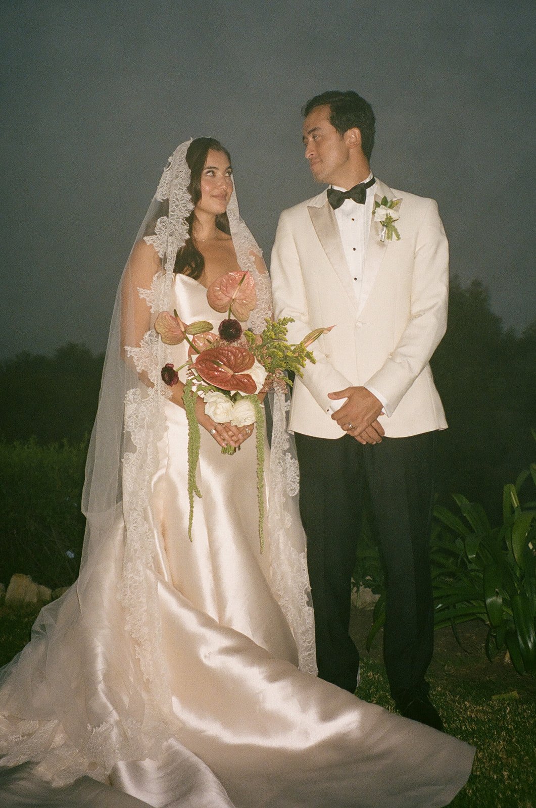 Bride and groom smiling together and looking at each other during formal portraits at a Historic Wedding Venue.