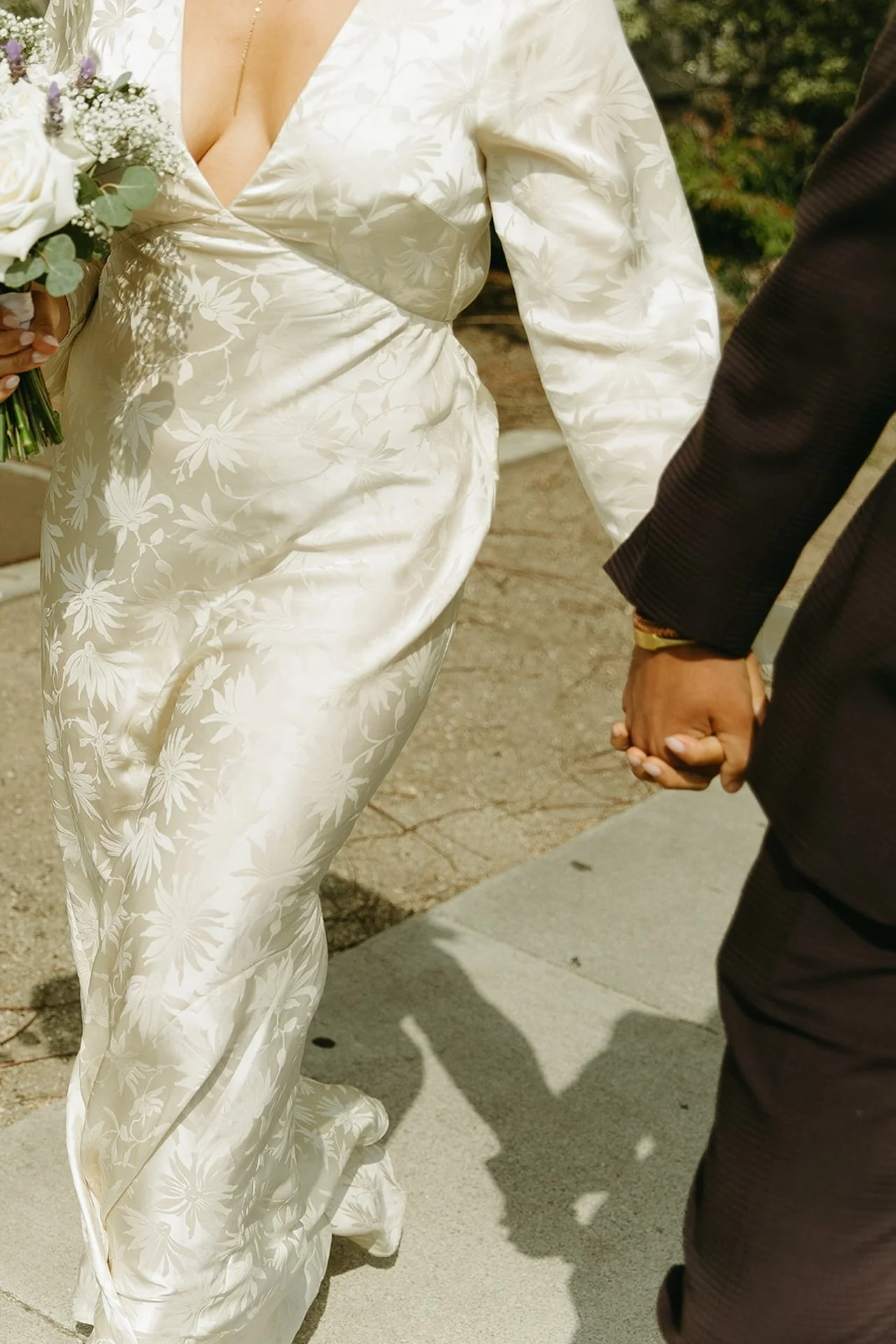 A close up shot of newlyweds walking on the sidewalk in Beverly Hills after their elopement ceremony