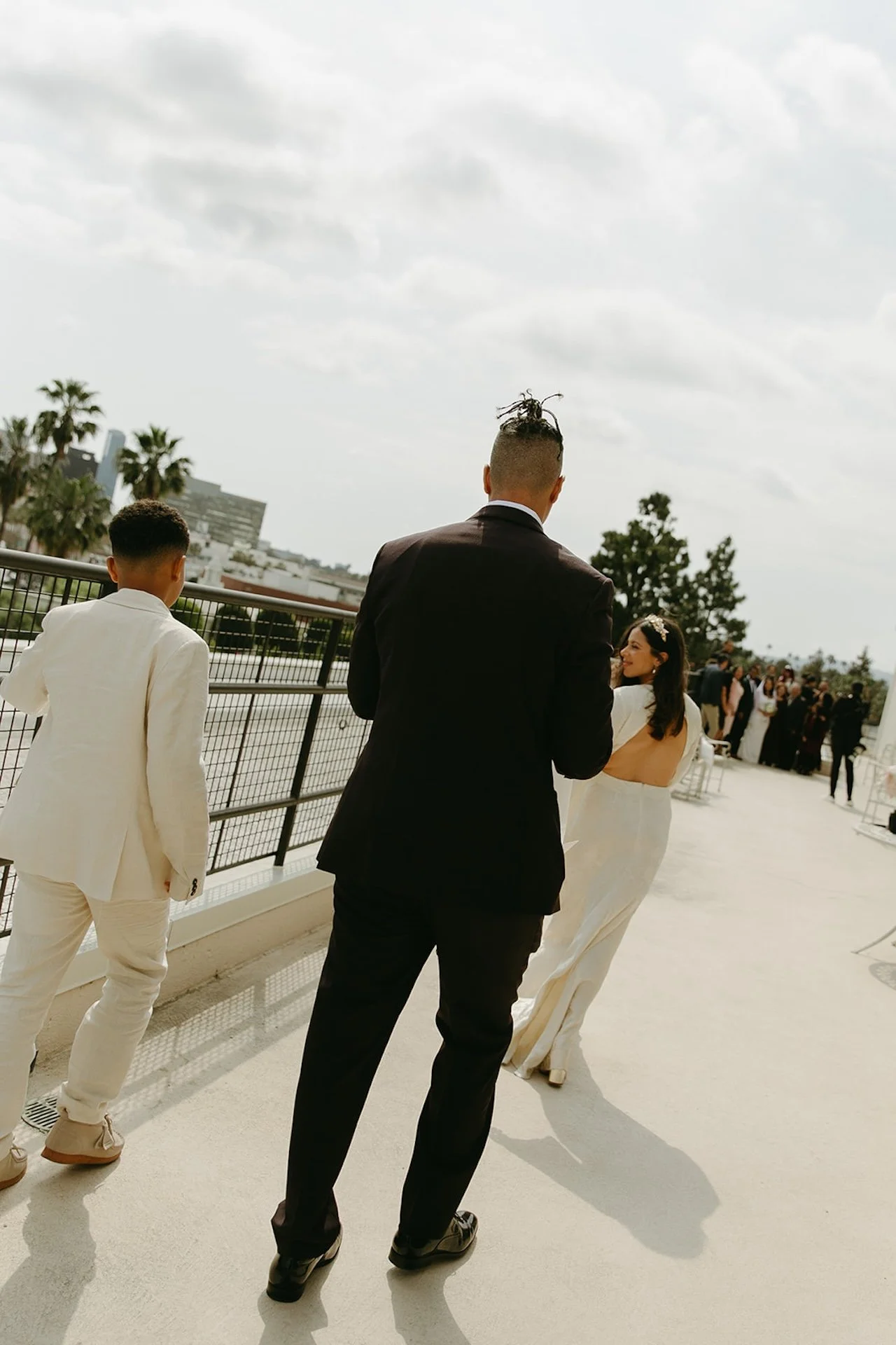 Newlyweds and their son walking down the street after their intimate Beverly Hills Courthouse Elopement