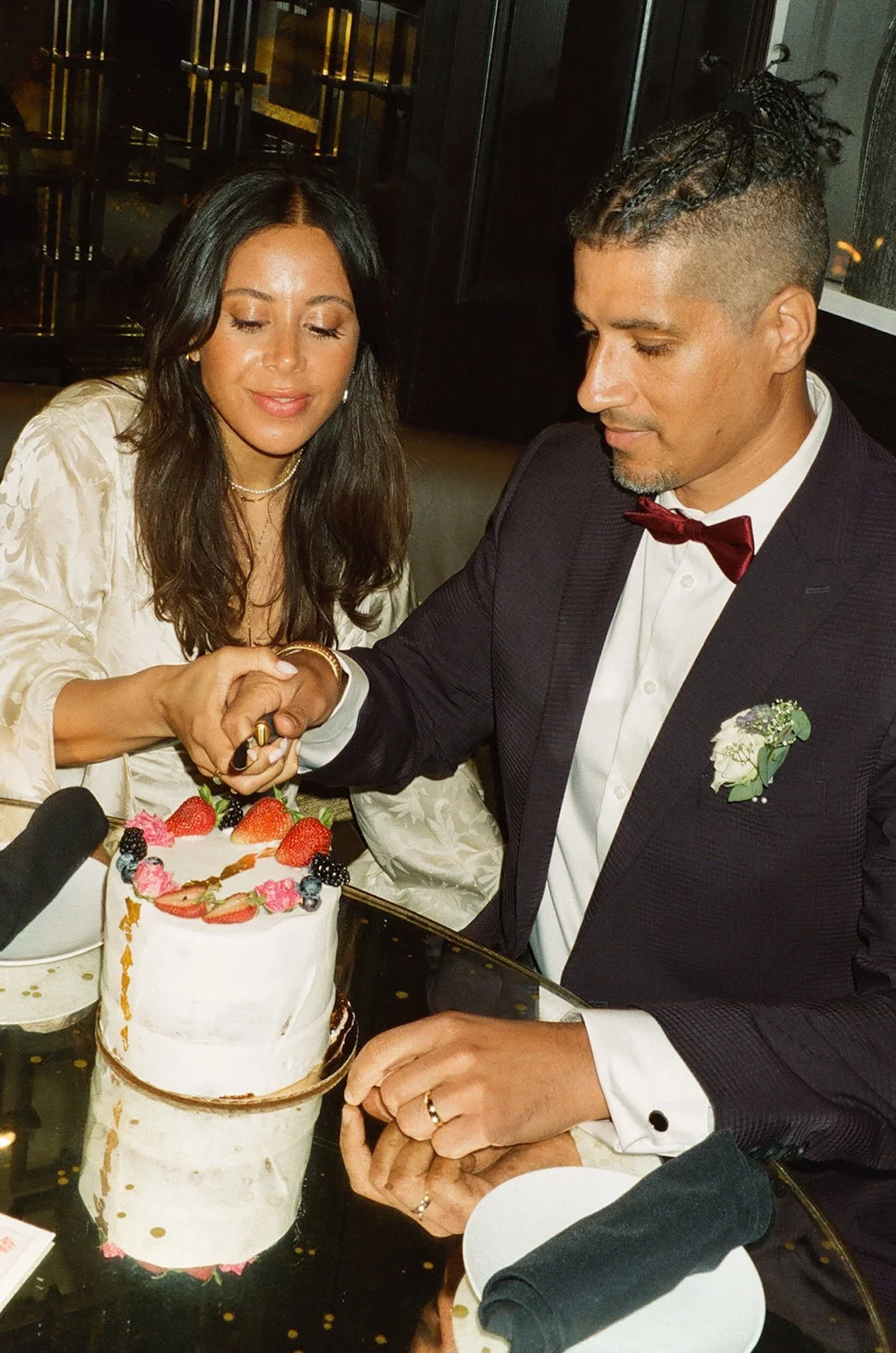 Bride and groom cutting their wedding cake together