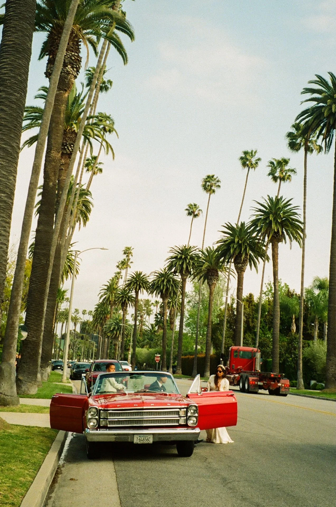 Detail photo of a red convertable on a palm tree lined street in Beverly Hills during their Beverly Hills Courthouse Elopement